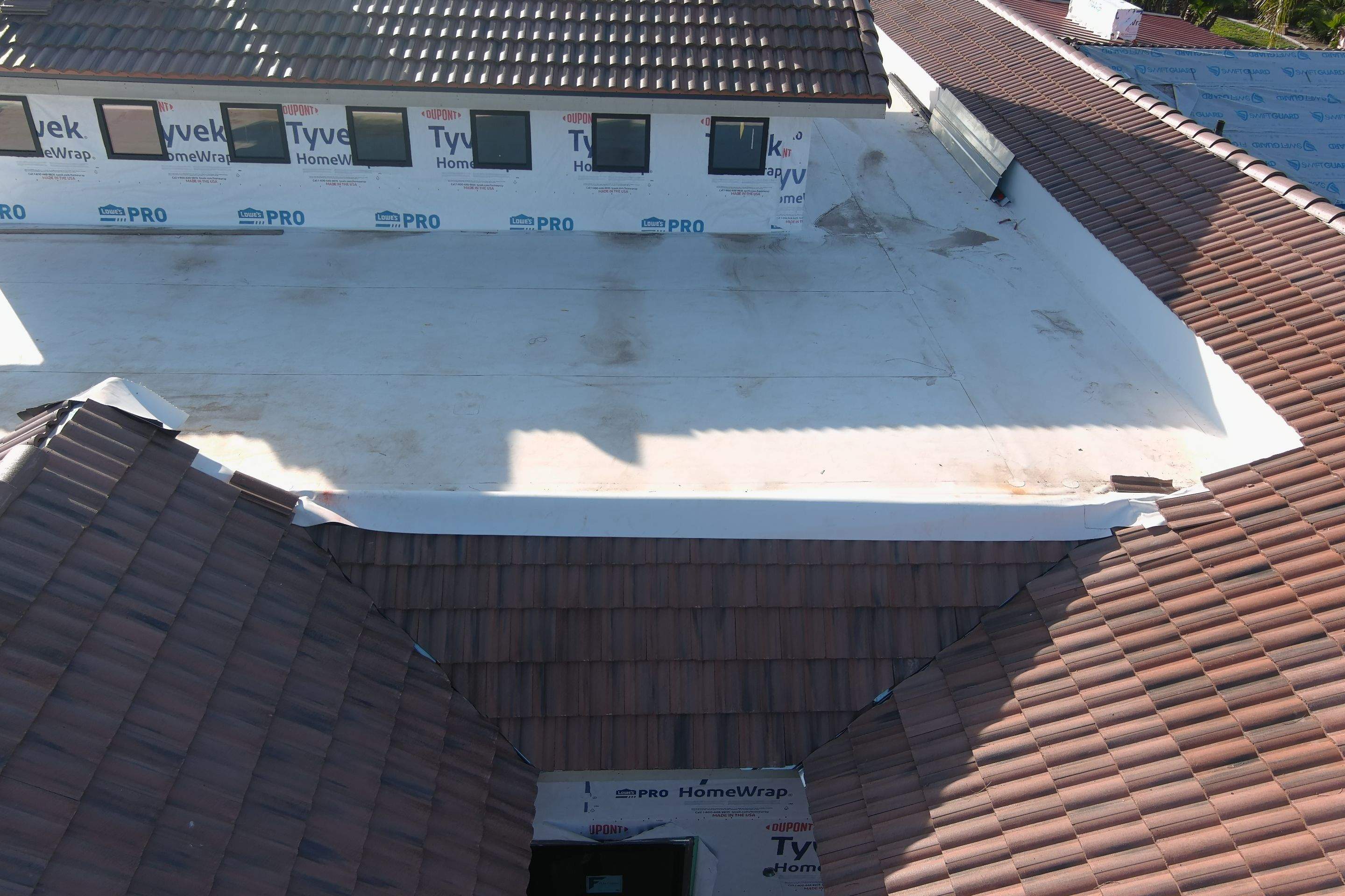 Tile, Metal, and TPO roofing project (new construction) by Straight Edge Roofing Inc