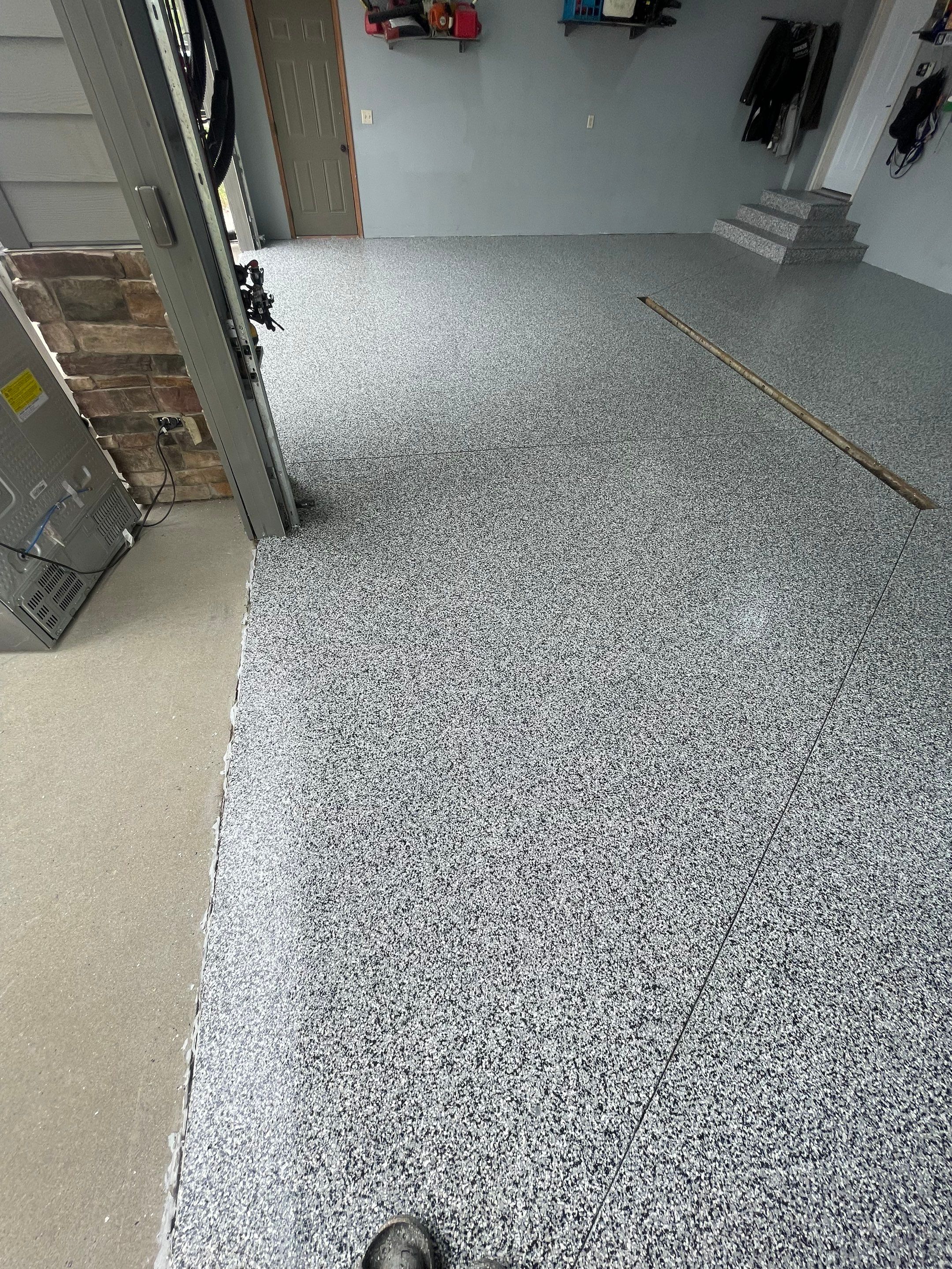 Full Garage Floor Epoxy Coating Installation in Dell Rapids by Select Painting, Coatings & Garage Cabinets