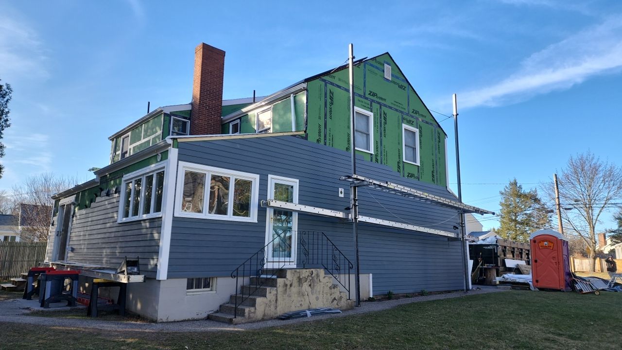 James Hardie siding, new metal roof and couple windows being installed. by UBrothers Construction