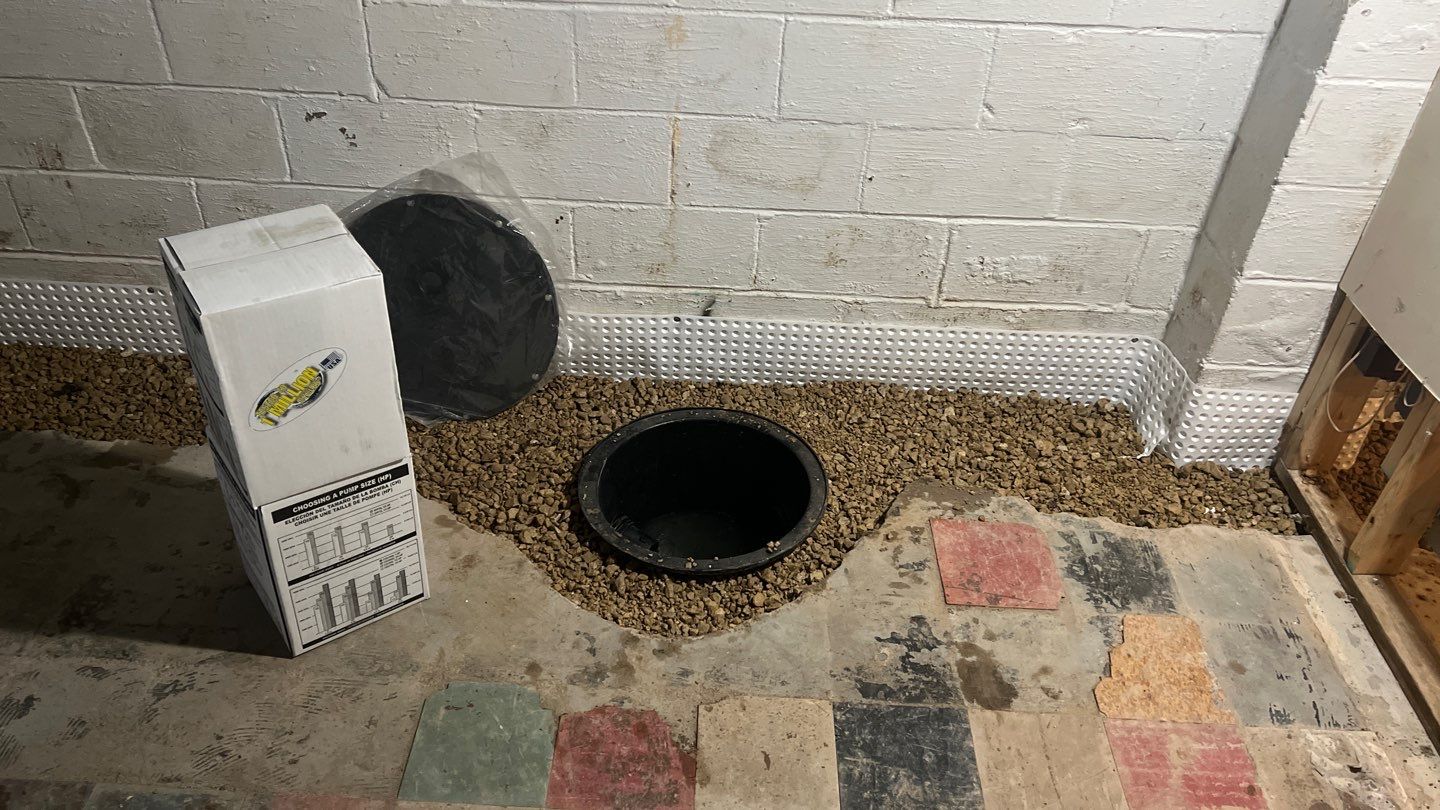 Interior drain tile system installation by ACE Waterproofing & Basement Solutions