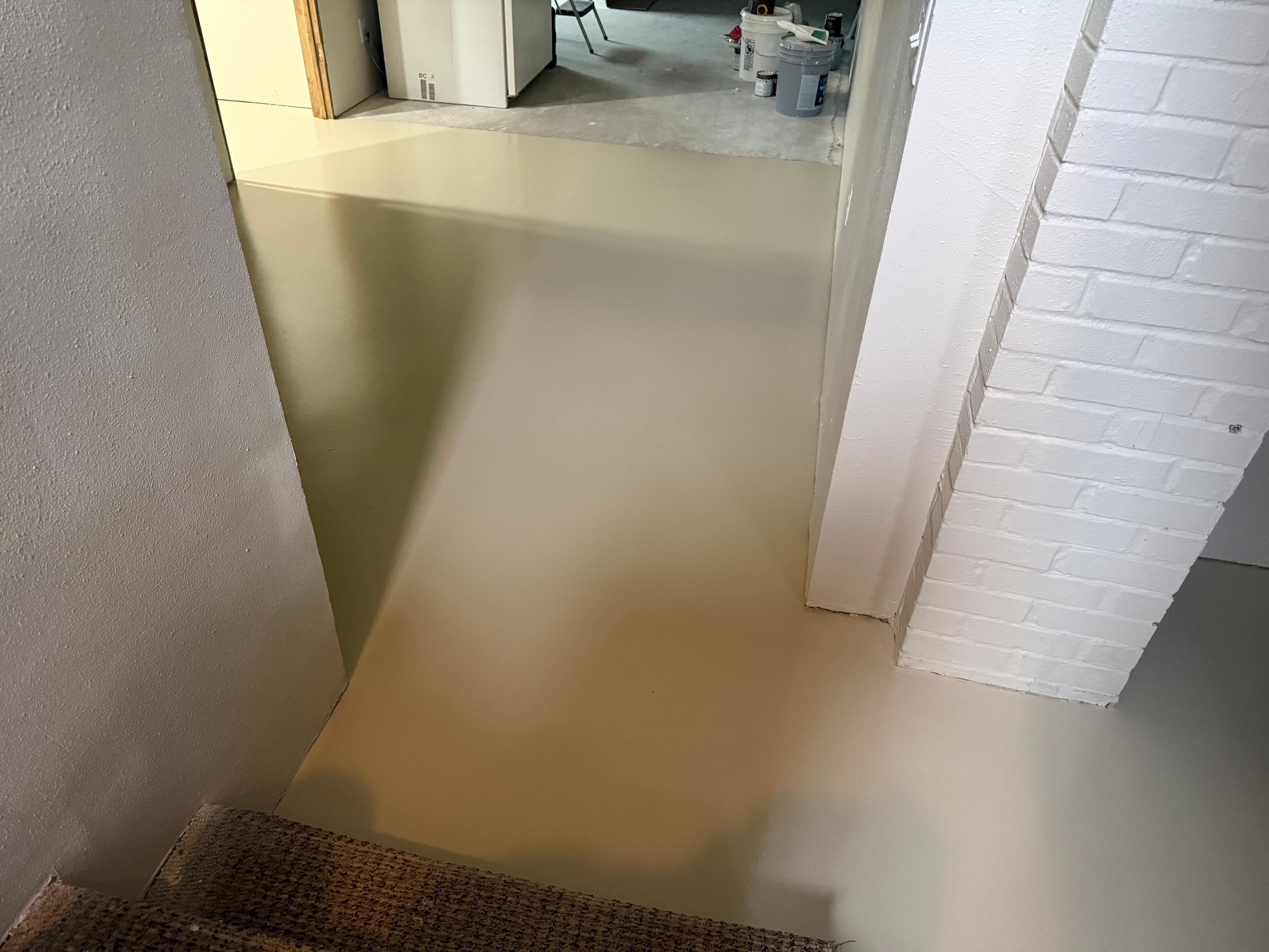 High-Gloss Epoxy Floor Coating and Basement Renovation in Rock Rapids by Select Painting, Coatings & Garage Cabinets