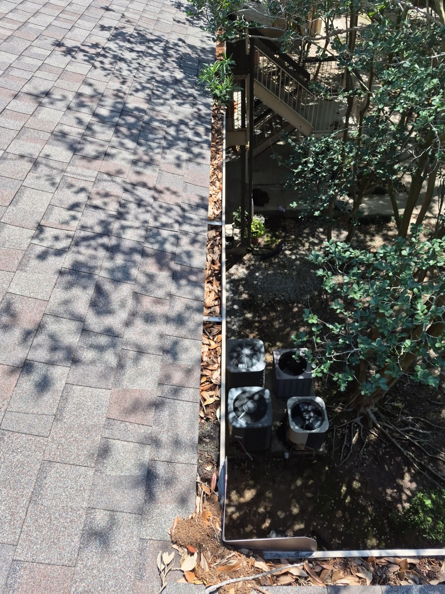 Commercial gutter cleaning Lafayette, LA before photo with filled gutters