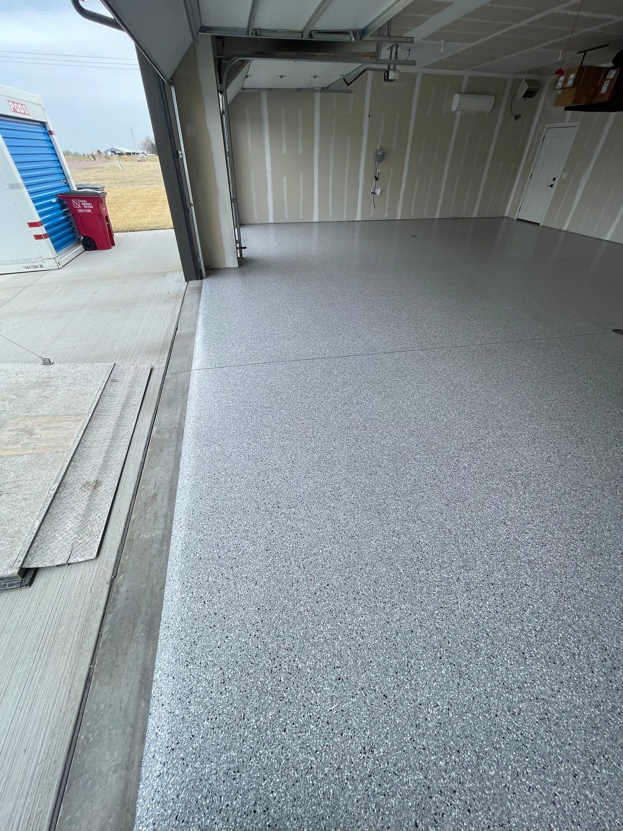 Grey Speckled Epoxy Floor Coating for Sioux Falls Garage by Select Painting, Coatings & Garage Cabinets