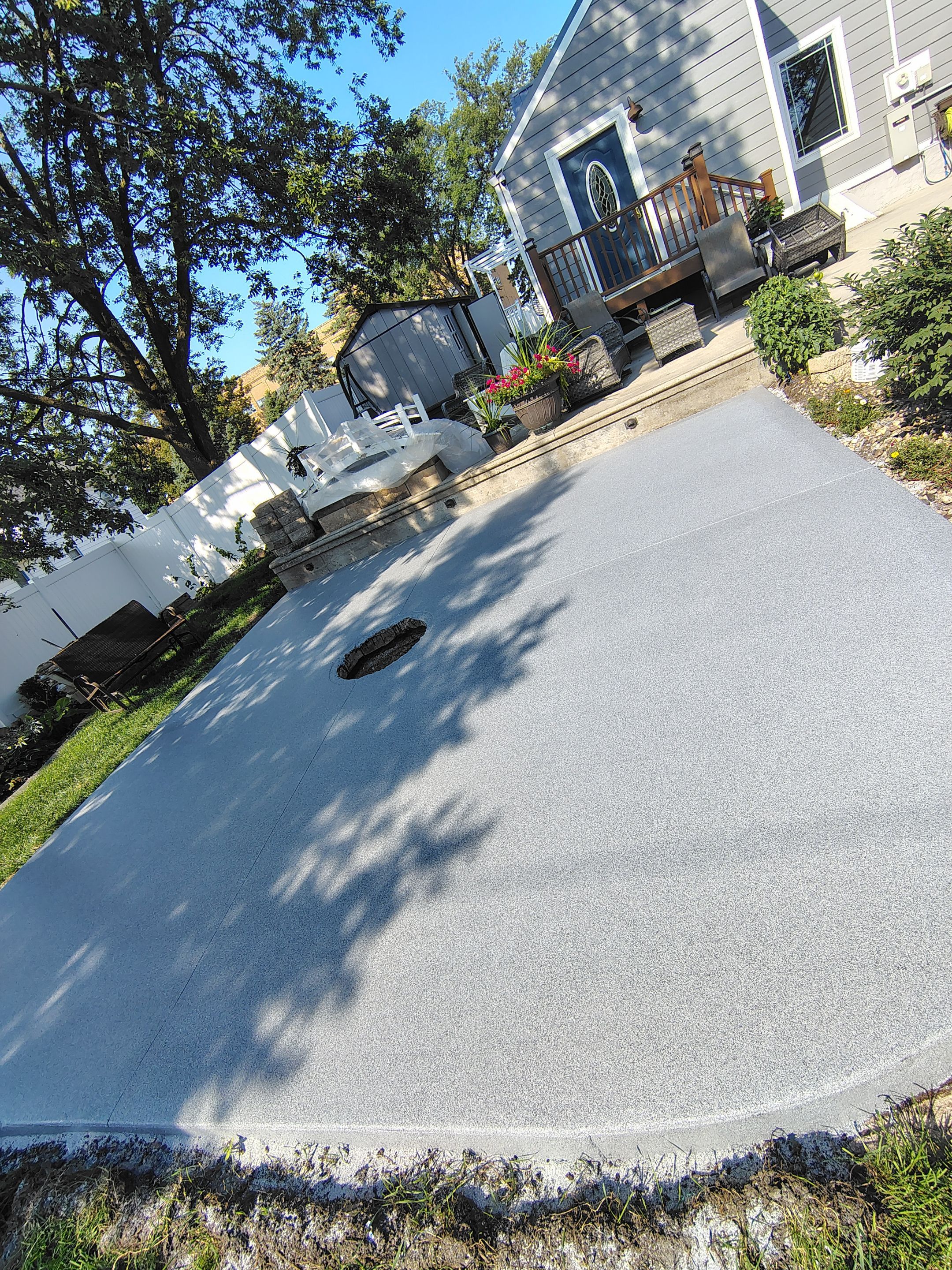 Custom Garage Floor Coating and Backyard Patio Refinishing in Tyndall by Select Painting, Coatings & Garage Cabinets