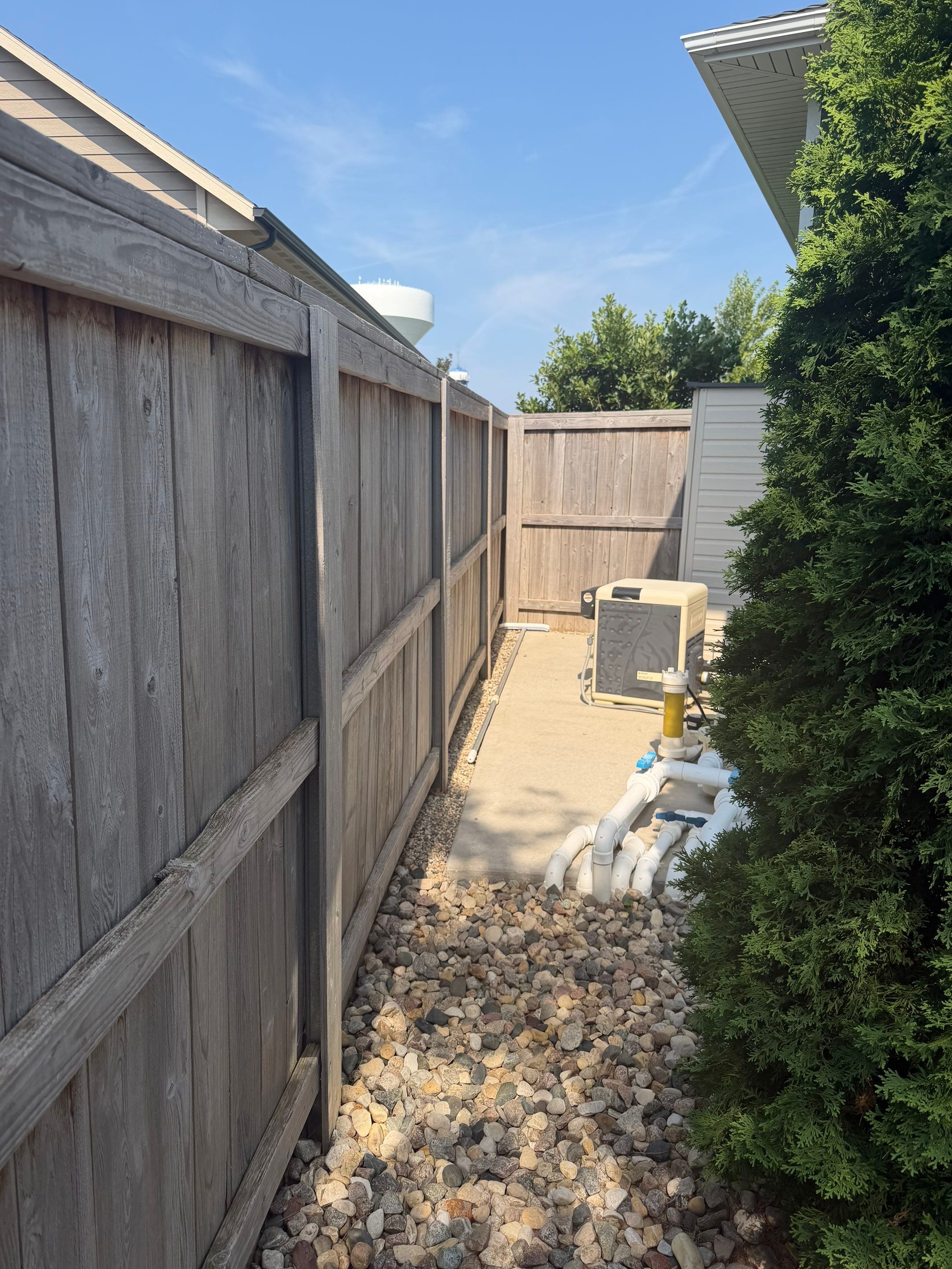 Custom Privacy Fence and Paver Patio Installation in Sioux Falls by Select Painting, Coatings & Garage Cabinets