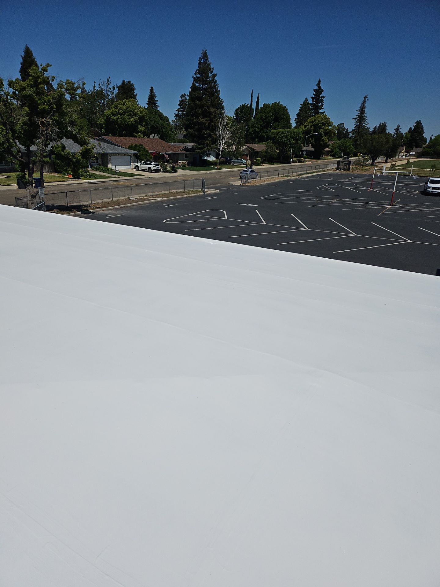 Single-ply restoration system using Benchmark/PUMA XL coatings over TPO single-ply roofing by Straight Edge Roofing Inc