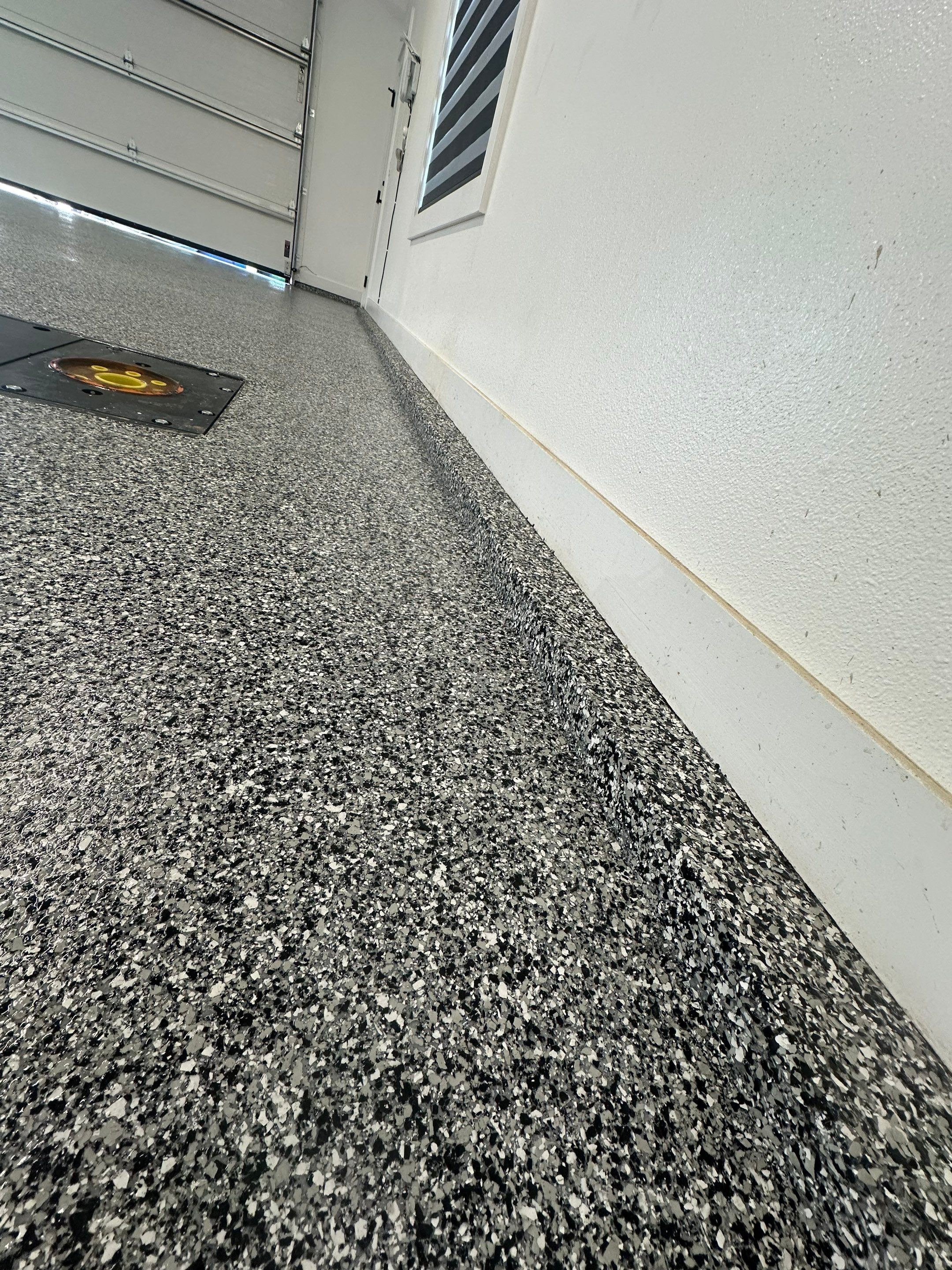 Multi-Color Epoxy Flake Garage Floor Installation in Sioux Falls by Select Painting, Coatings & Garage Cabinets