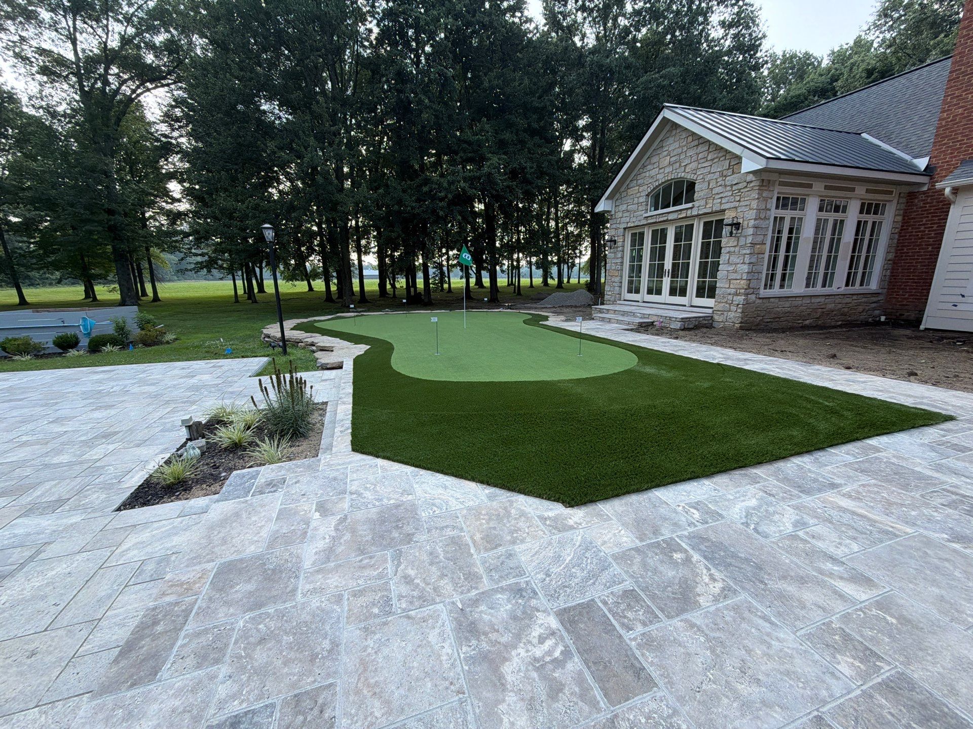 Custom Backyard Golf Green Accented by Flagstone Border in Morrow, OH by Southwest Greens Midwest