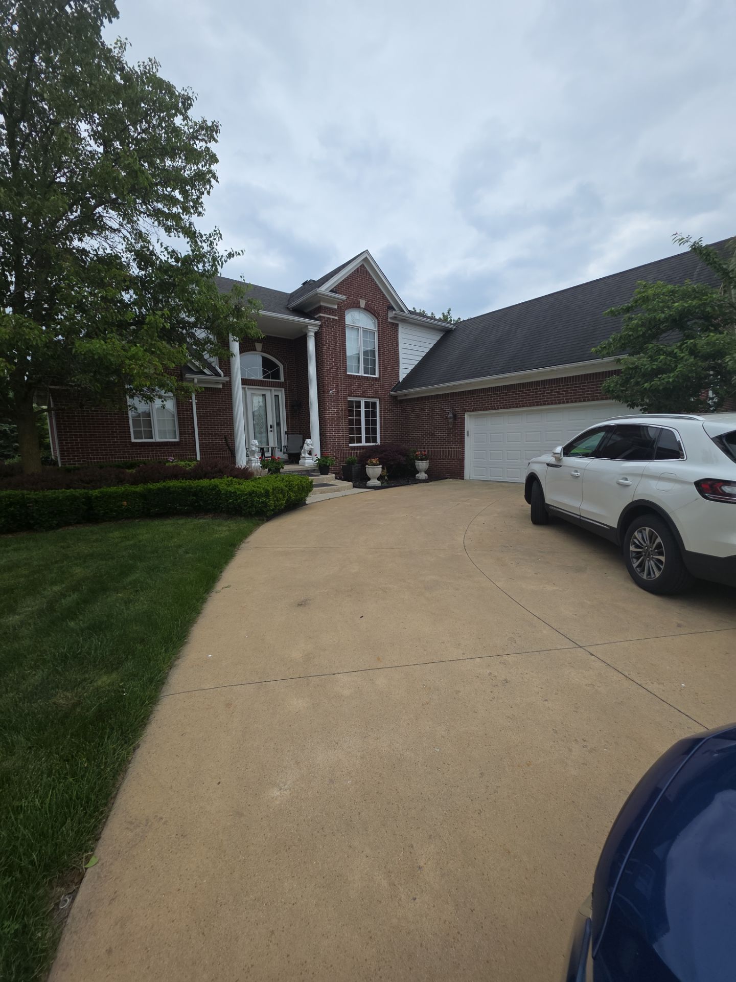 Siding and Trim Repair and Exterior Painting for a Macomb Brick Residence by Top Shelf Painter