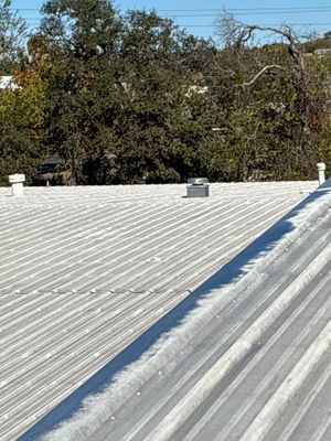 Metal roof section meeting a flat roof membrane