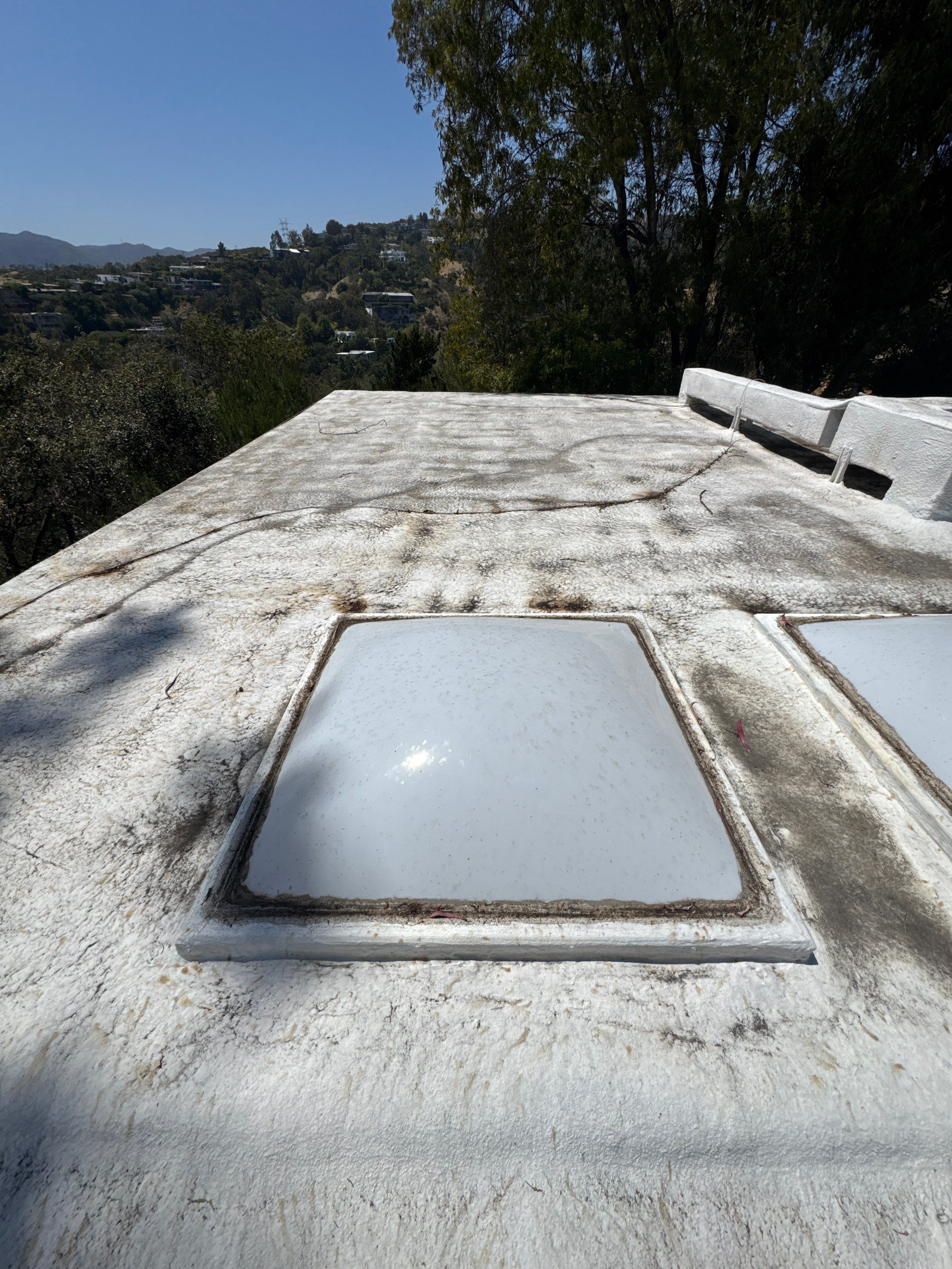 Residential Flat Roof Restoration with Silicone Coating in Brentwood by Hull Brothers Roofing