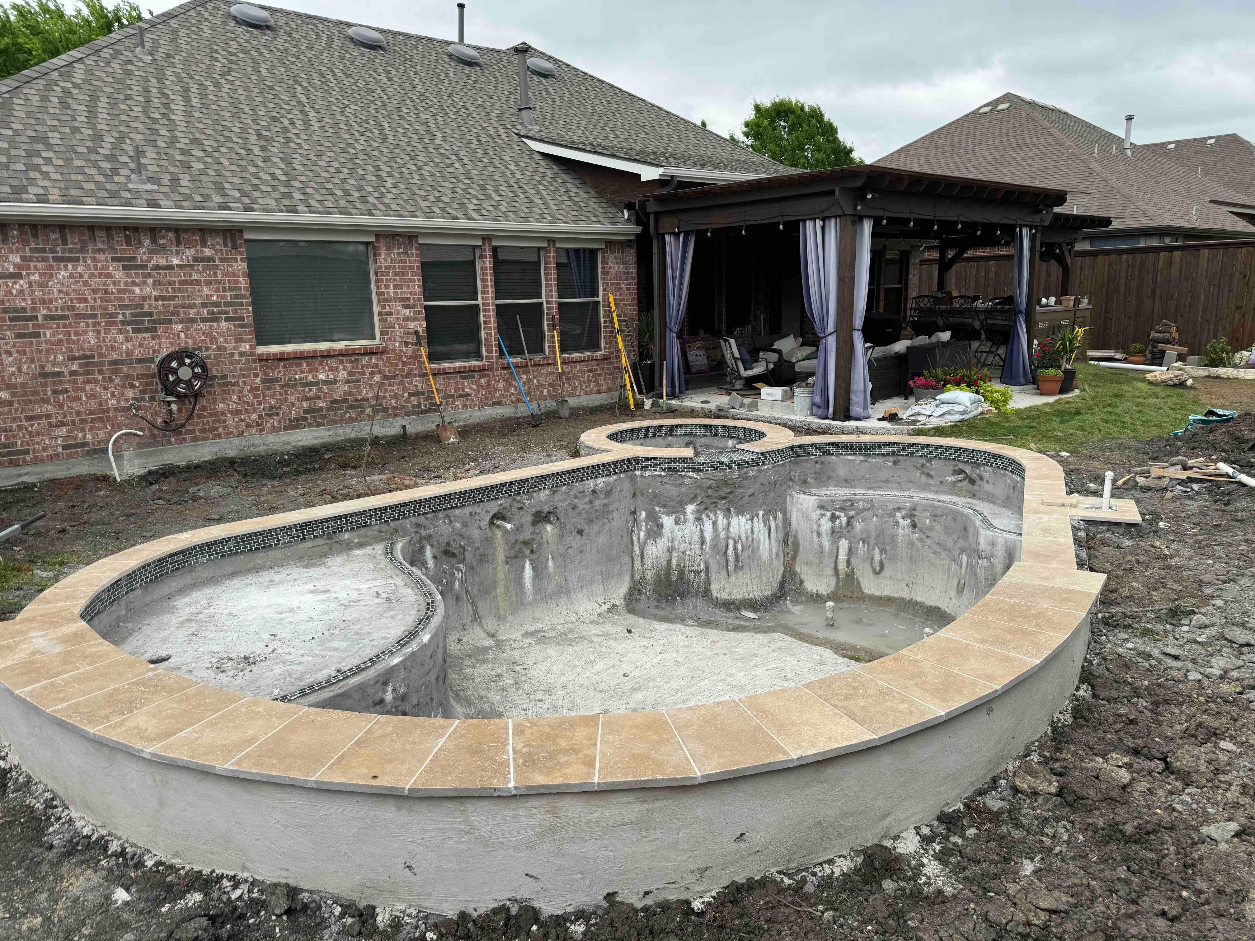 Freeform Pool with Raised Spa and Stone Veneer by Pinnacle Pools and Spas - DFW