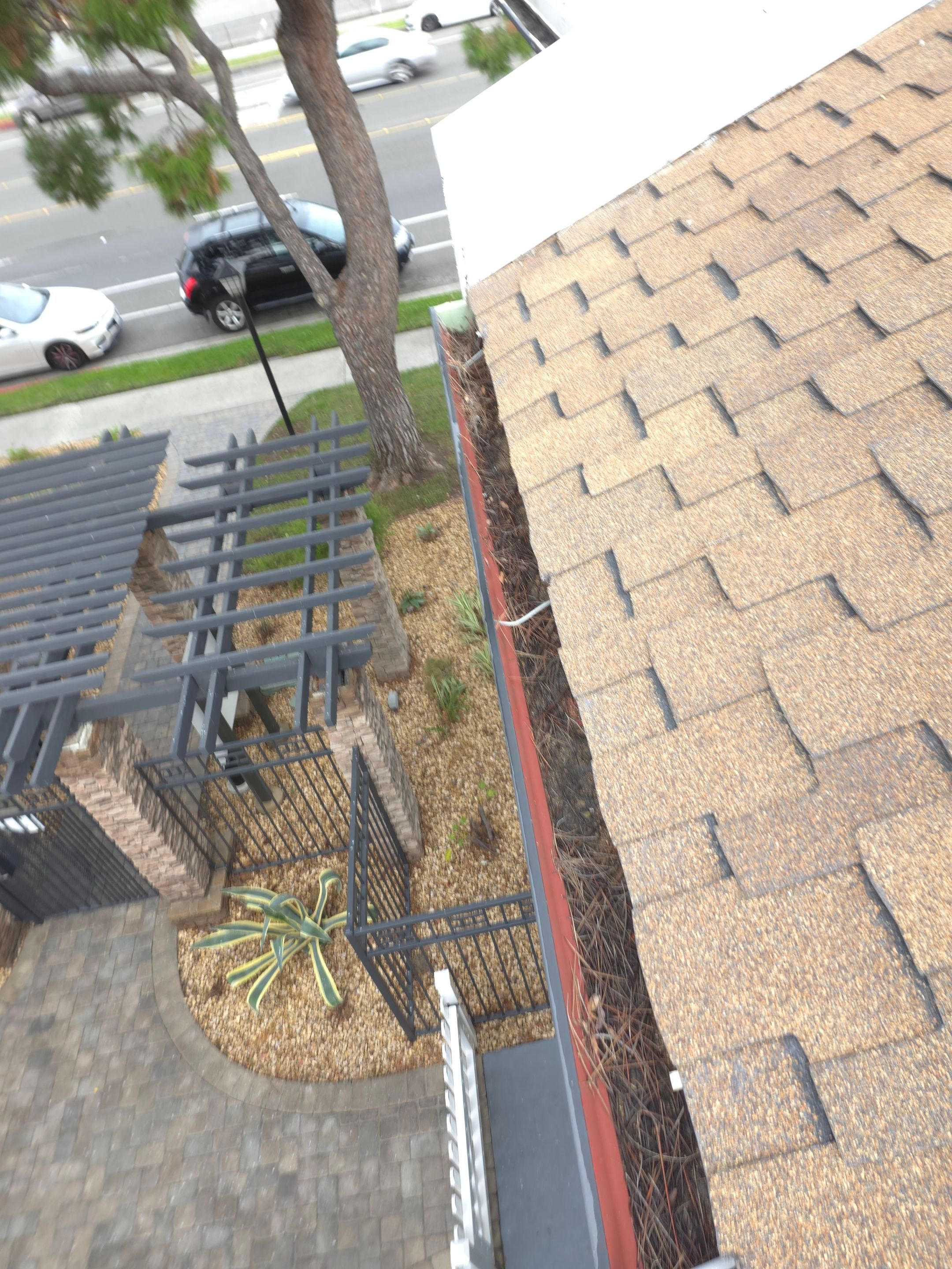 Commercial gutter cleaning Irvine & Newport Beach before photo with filled gutters