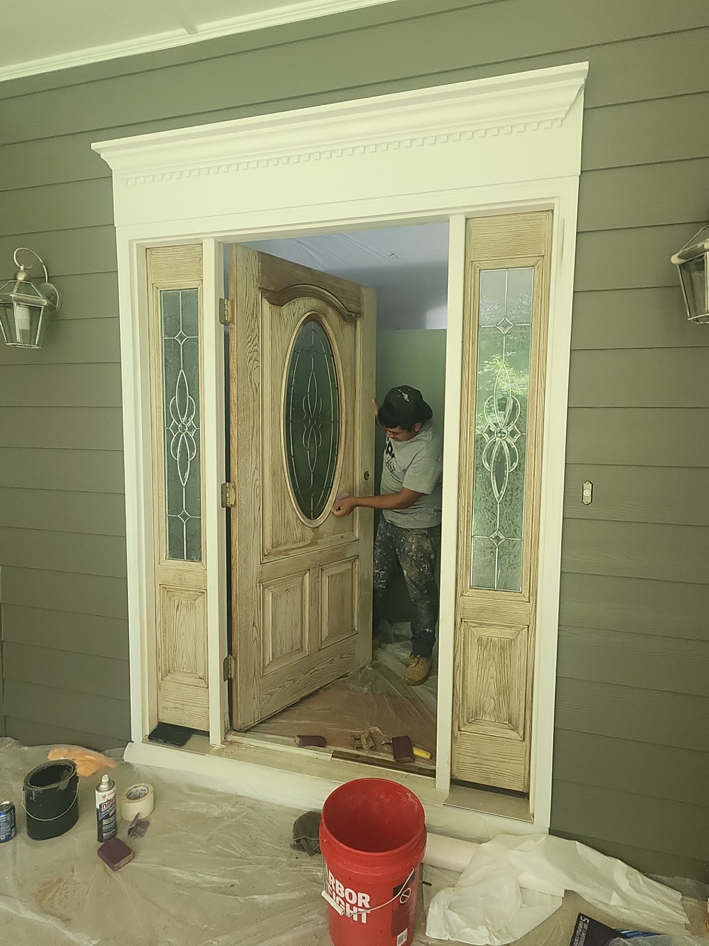 Siding replacement, exterior painting, and front door staining. by GonzalezPainters & Contractors Inc