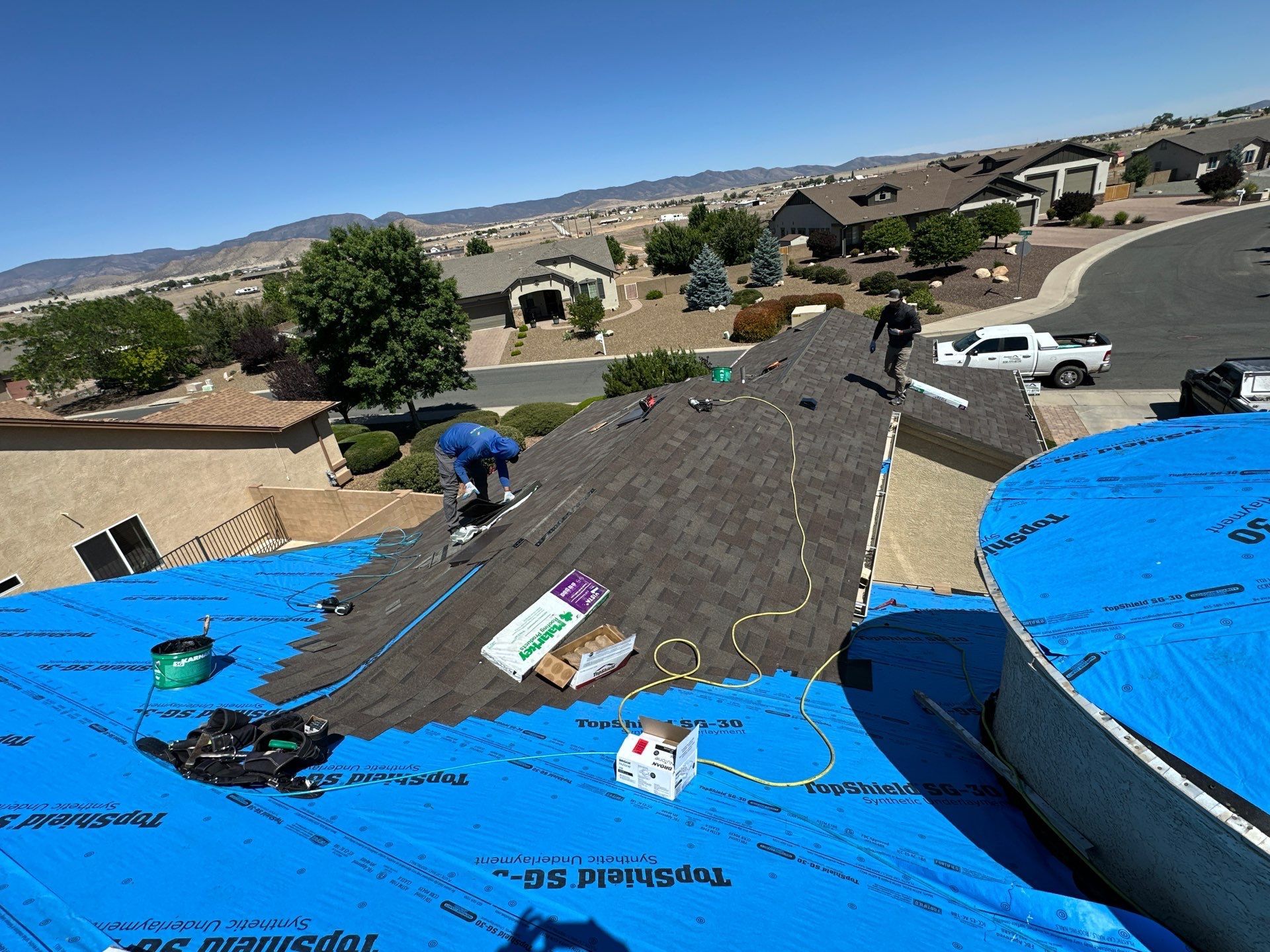 Residential Roofing Installation with Architectural Shingles and Turret Detail by Badger Roofing
