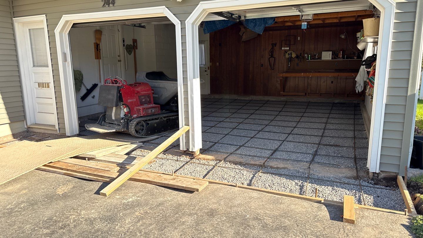 Concrete garage floor replacement with a broom finished apron by NG Masonry & Construction LLC