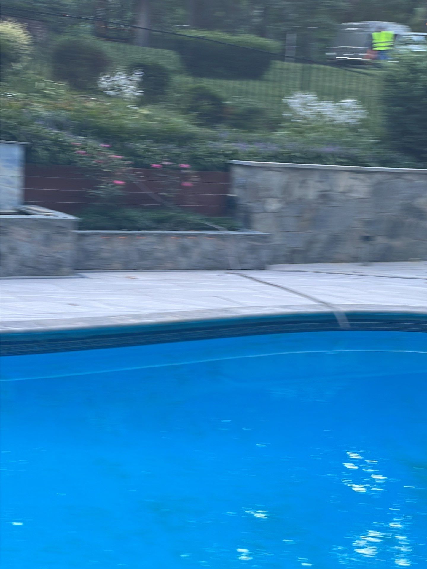 Pool Surround remodel with retaining walls, new waterfall and water slide by Fairfax Contractors, LLC