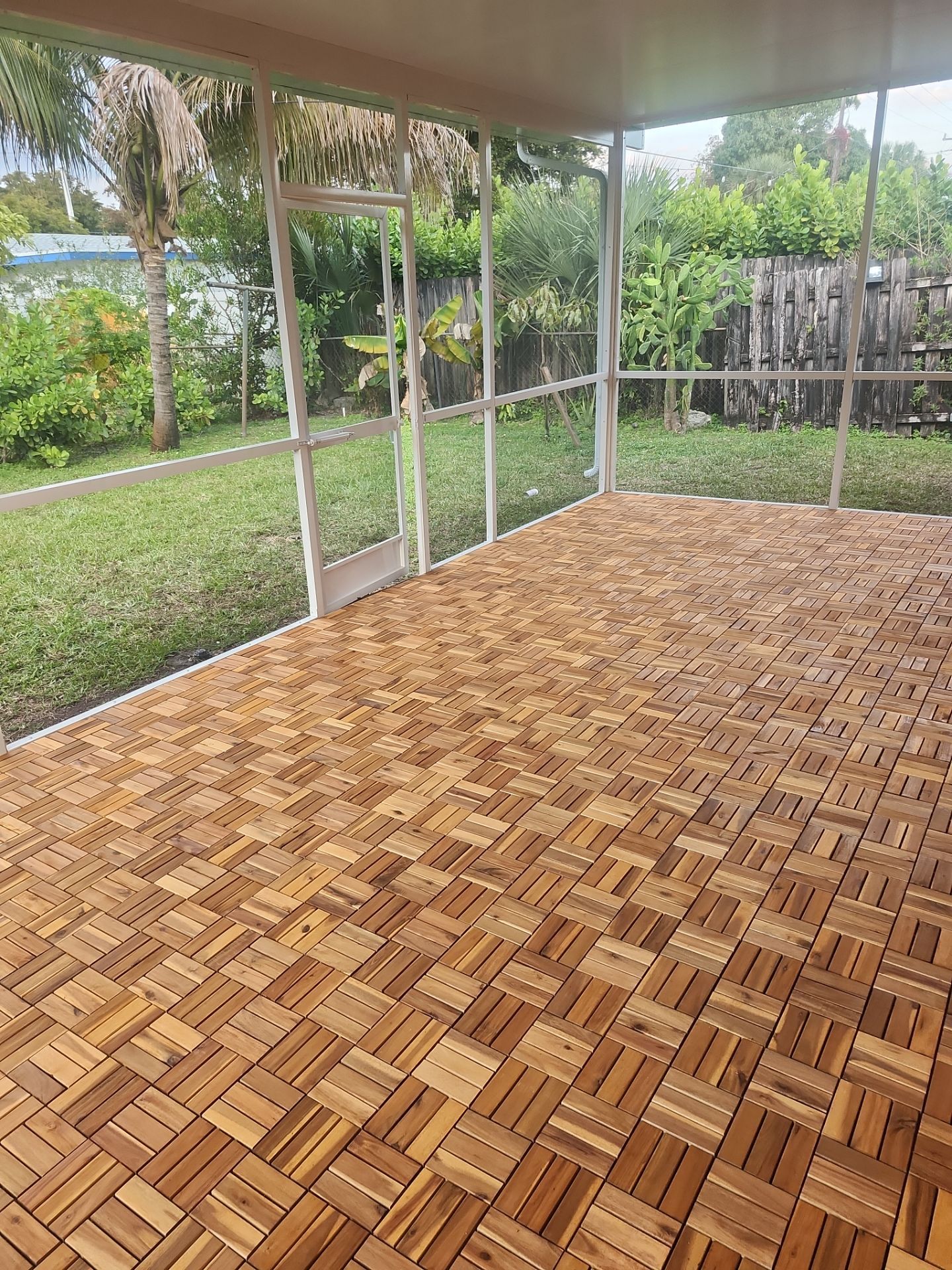 Insulated Screen Enclosure and Wood Tile Deck Installation in Plantation by Aastro Roofing