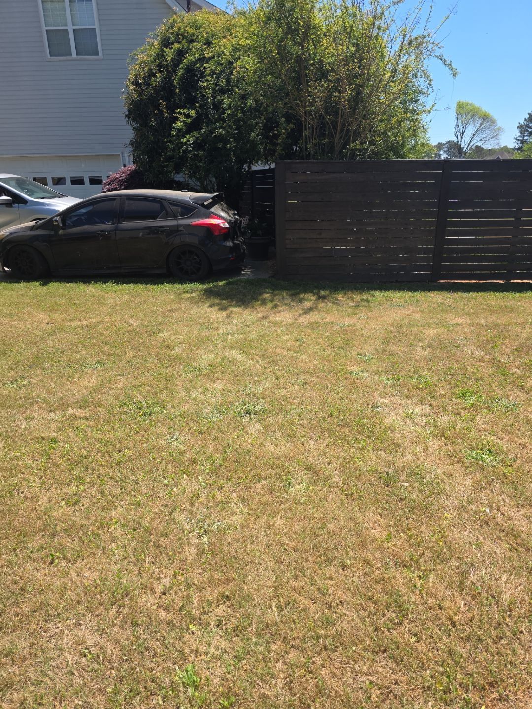 Fence Installation of a Capped Wood Privacy Fence by Titans of Timber Fence & Stain