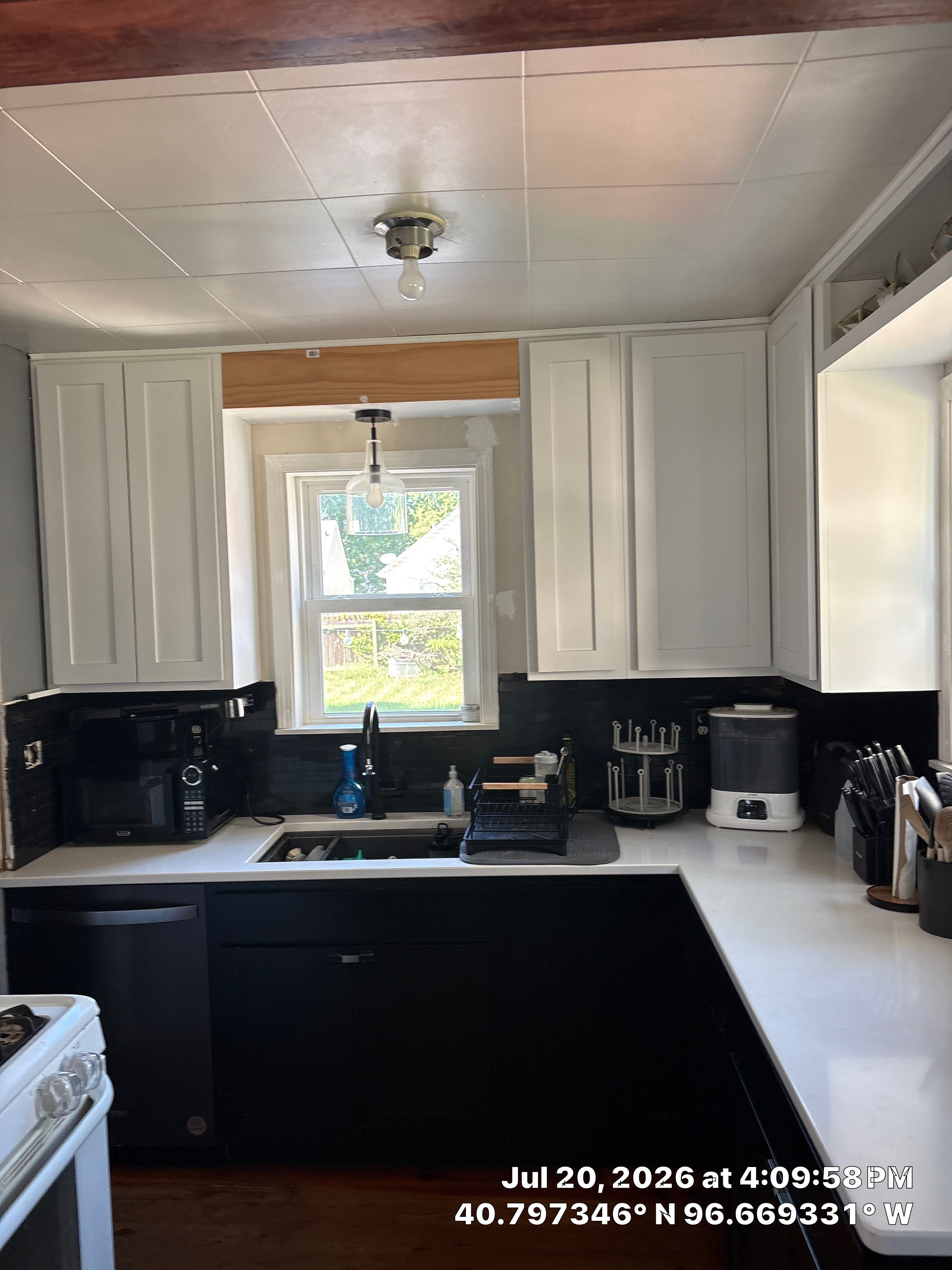 Kitchen Remodel in Lincoln Nebraska Featuring Two-Tone Cabinetry and Black Backsplash by CompanyCam Sales Demo