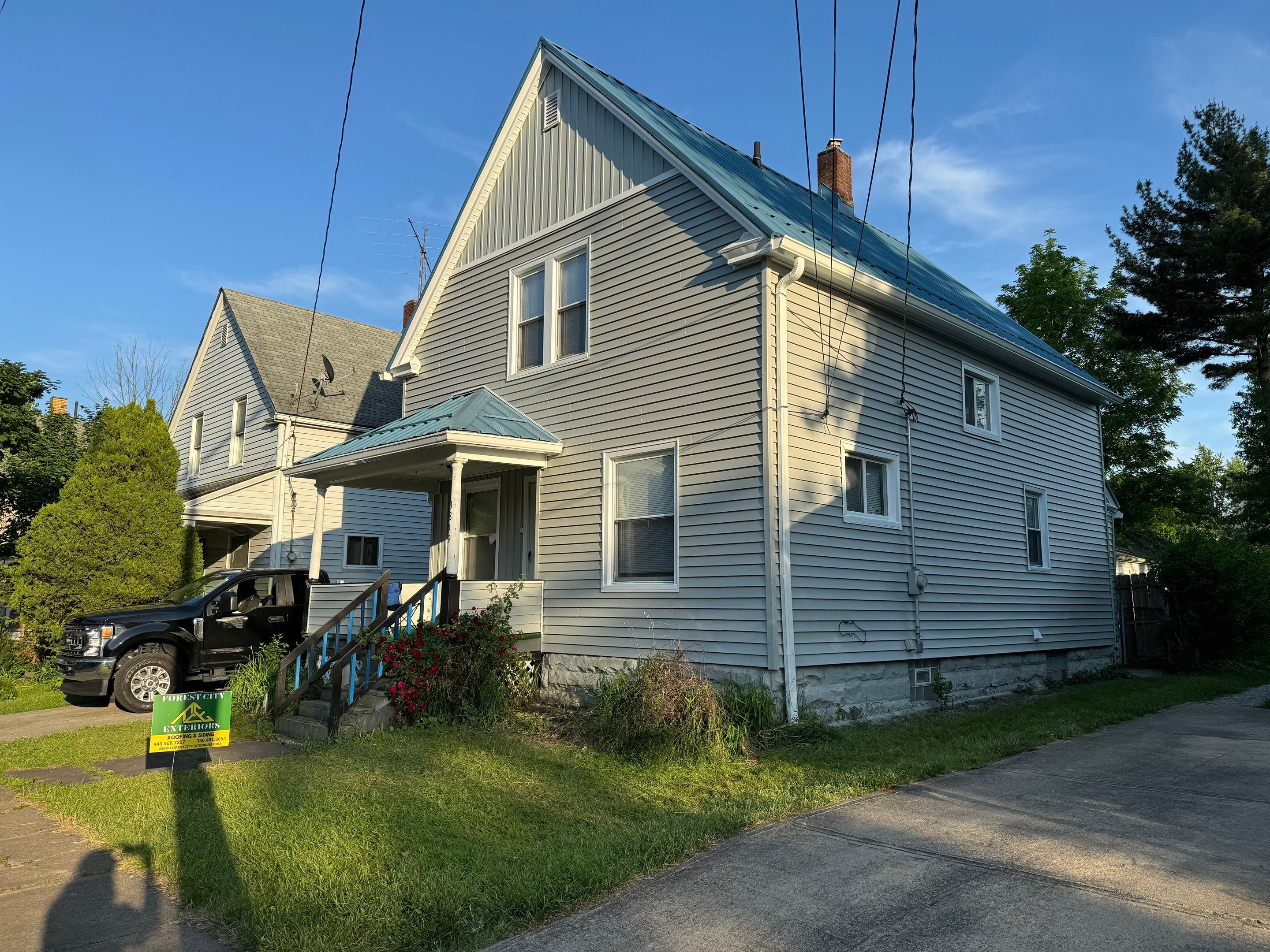 Exterior Remodel using Alside Charter Oak, Premier Metals Custom Metal Roofing by Forest City Exteriors