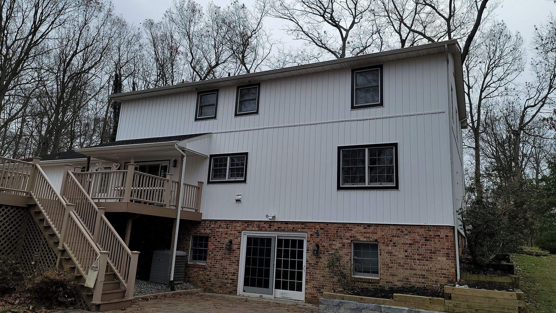 White Board & Batten Siding with Black Trim by Roof Right Inc