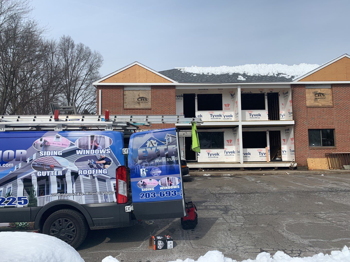 Commercial Roofing Installation using EPDM with white gutters by A Plus Exterior