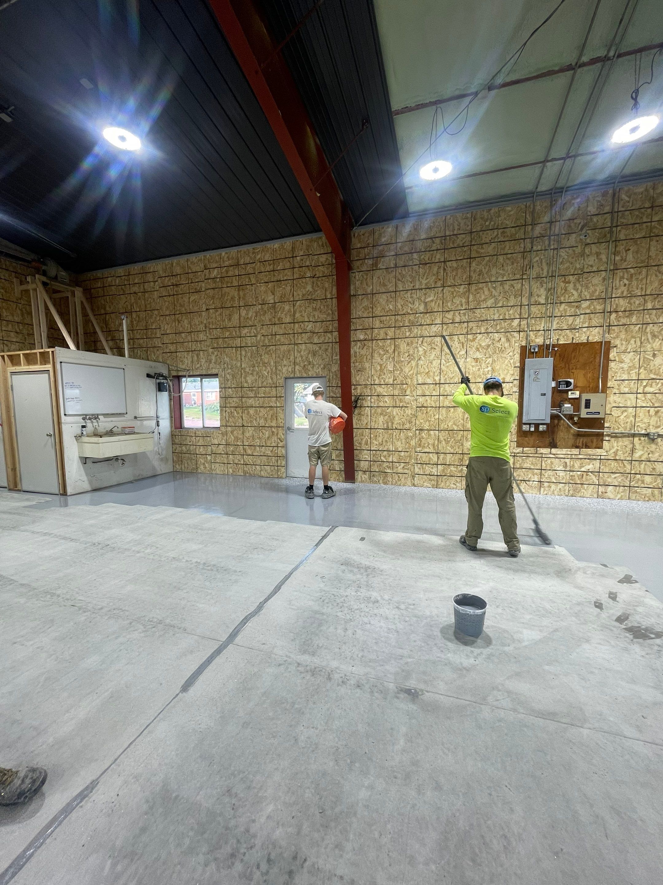 Custom Polyurea Shop Floor with Basketball Court Lines in Rock Valley by Select Painting, Coatings & Garage Cabinets