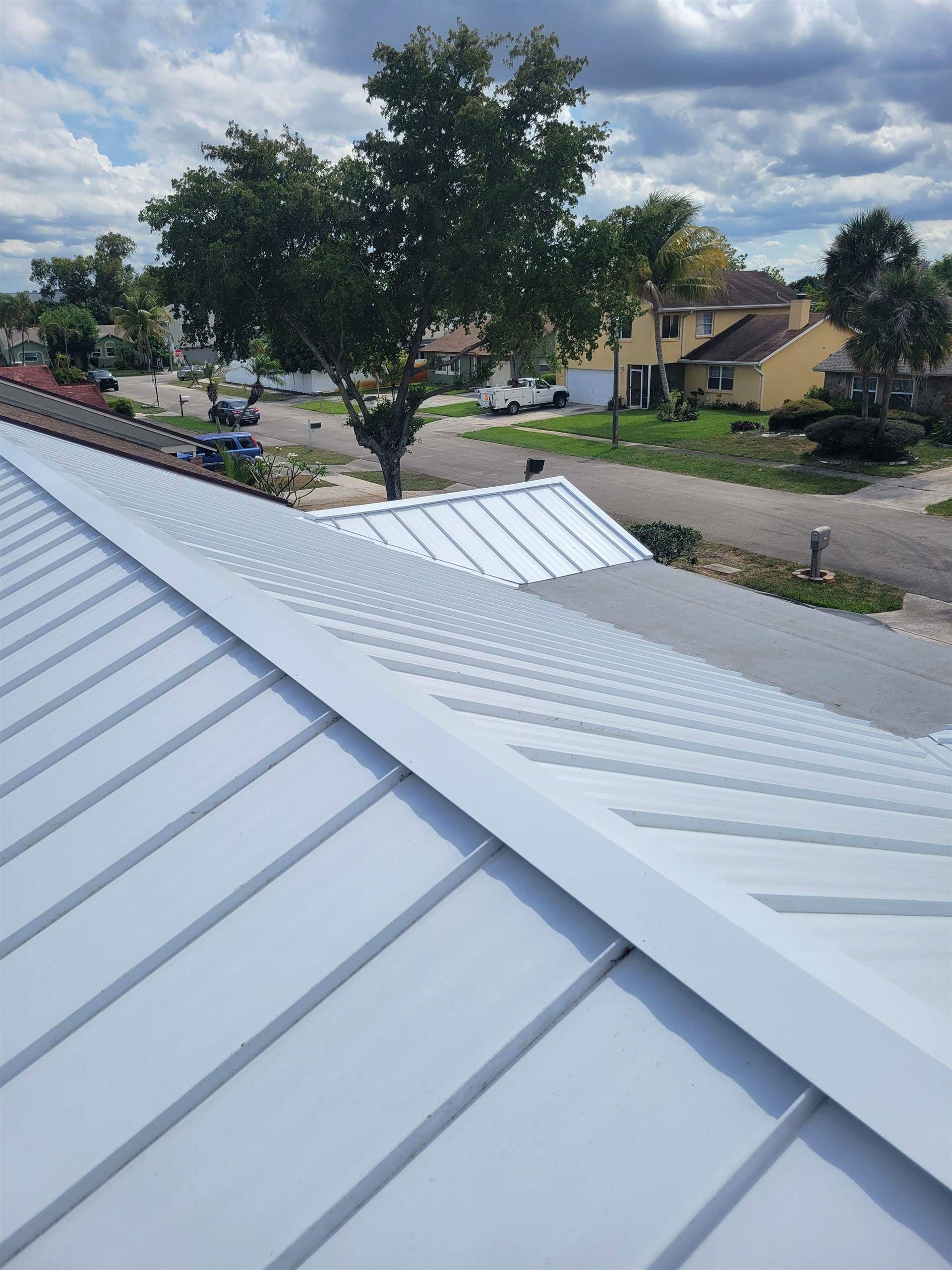 Standing Seam Metal & Flat Re-Roof using 1.5" Nail Strip 24ga Solar White Kynar Coated Standing Seam Metal Panels by Morton Roofing, Inc.