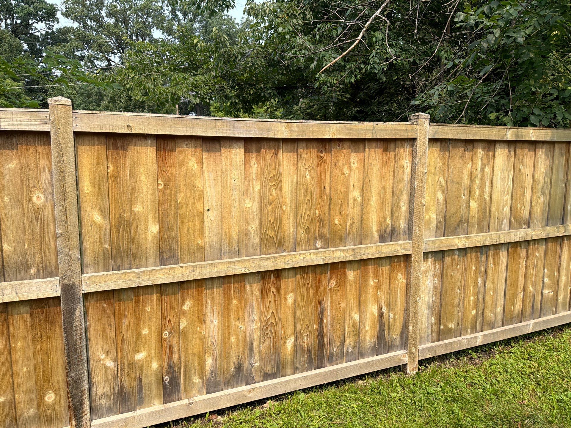 Wood fence cleaning and sealing by Northern Power Washing LLC.