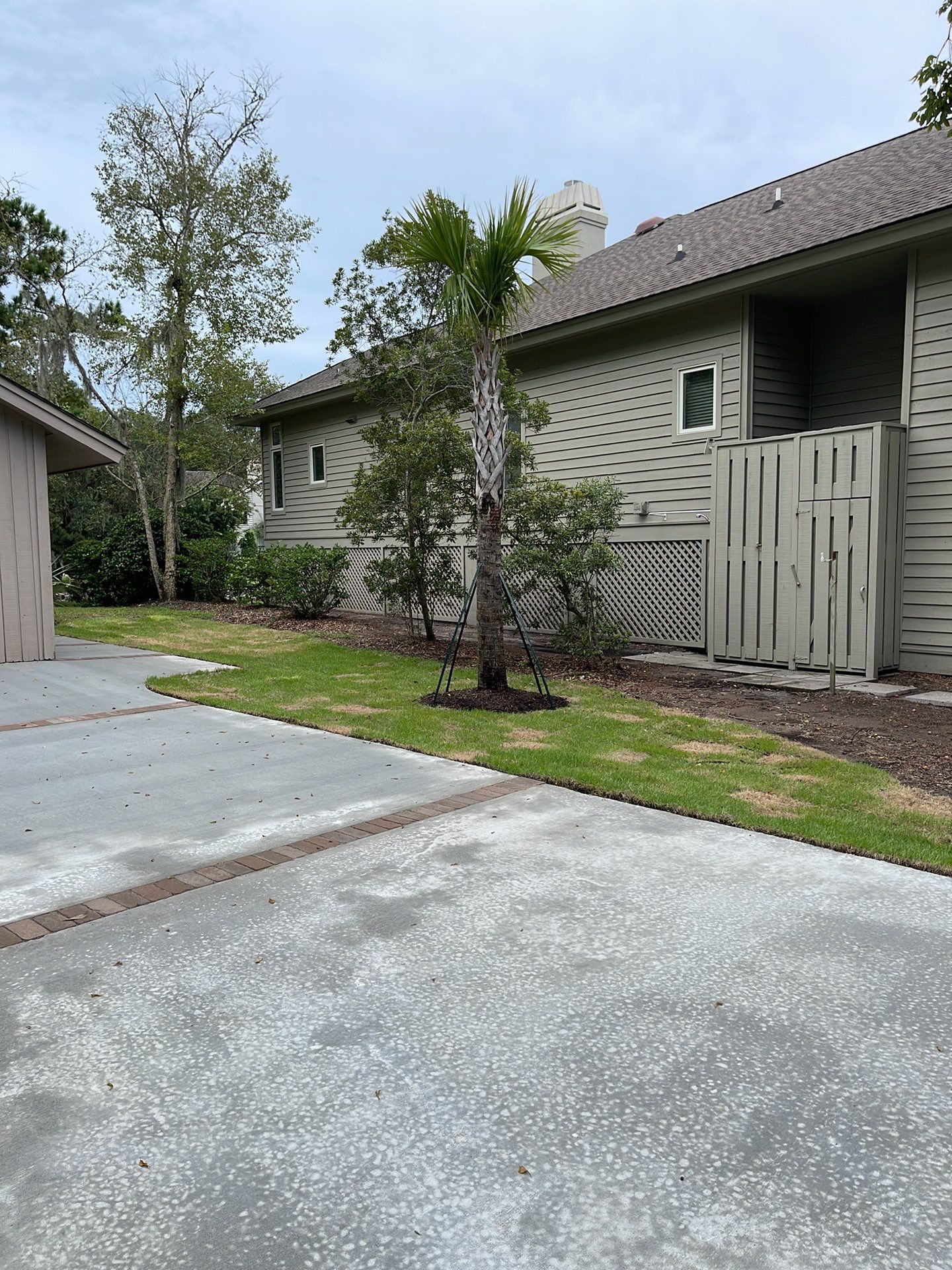 Concrete Driveway Replacement with Brick Paver Accents in Hilton Head Island by Lowcountry Scapes, LLC