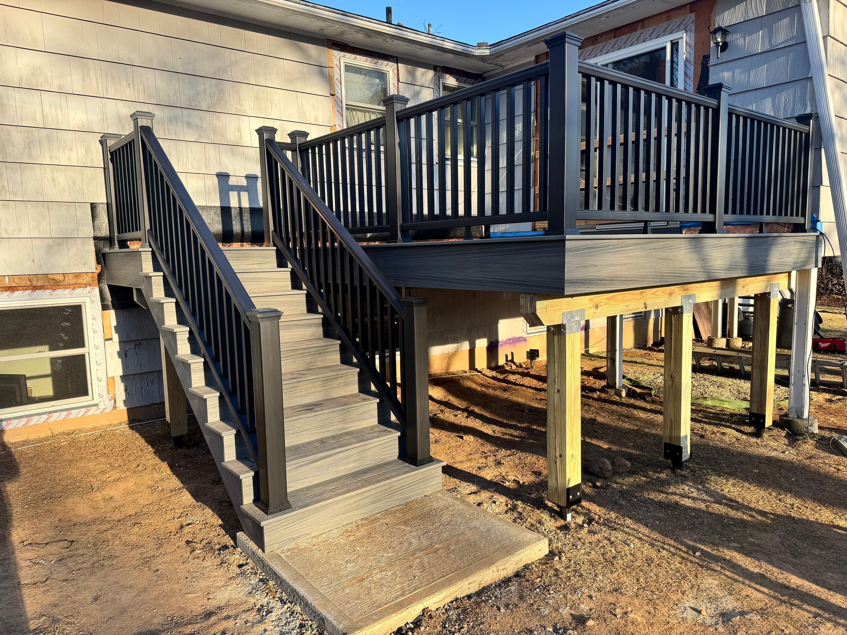 New Deck, Trex Tropical Island mist boards and Fascia. Black composite trex railing. by DiGiorgi Roofing and Siding Inc