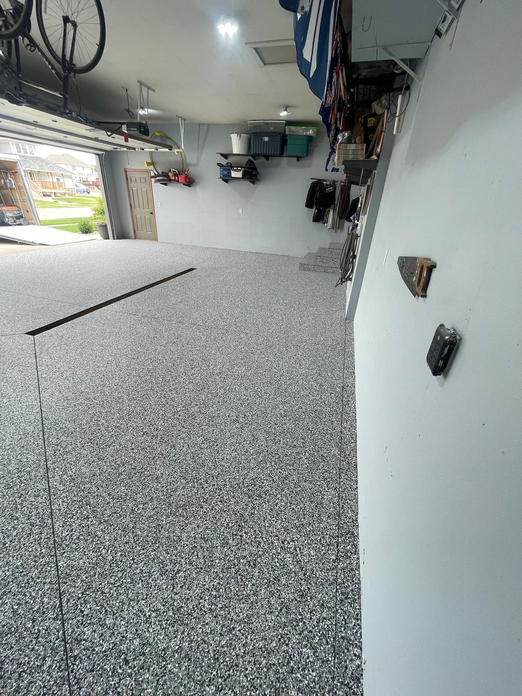 Full Garage Floor Epoxy Coating Installation in Dell Rapids by Select Painting, Coatings & Garage Cabinets