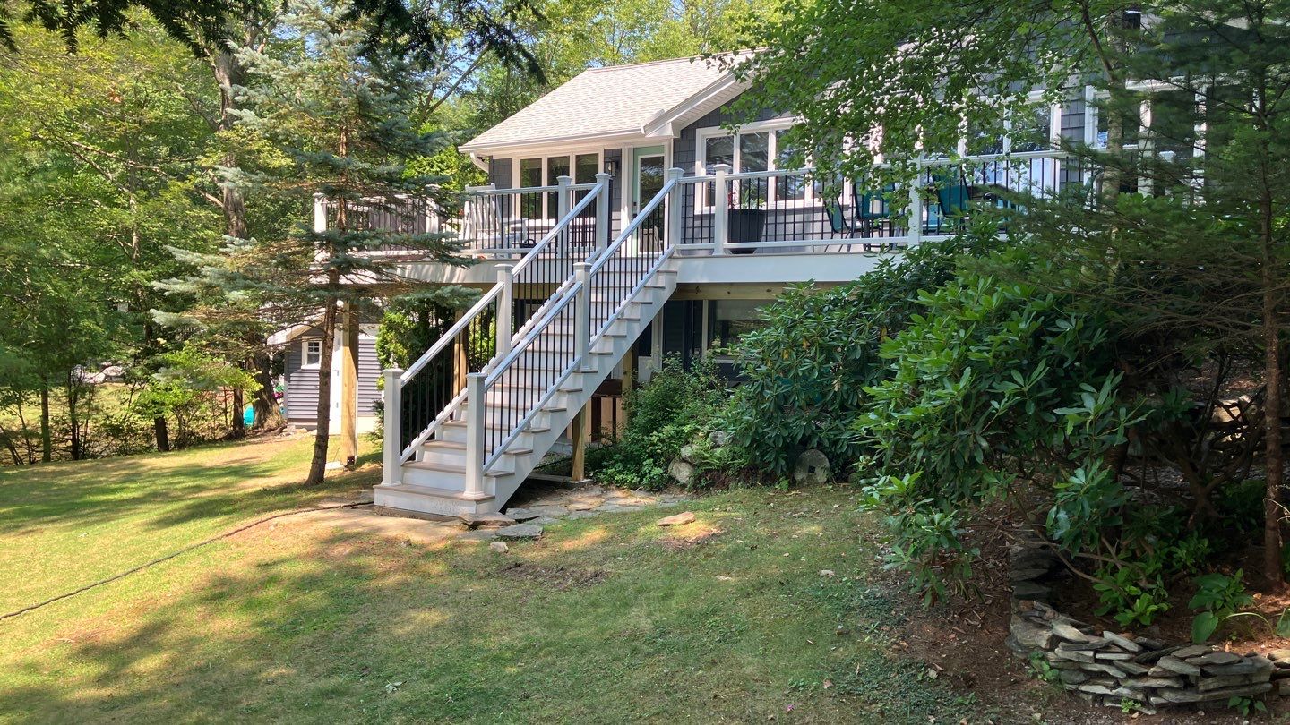 Deck replacement using Trex Transcend Rope Swing and Transcend Railings.Trex Rainescape by DiGiorgi Roofing and Siding Inc