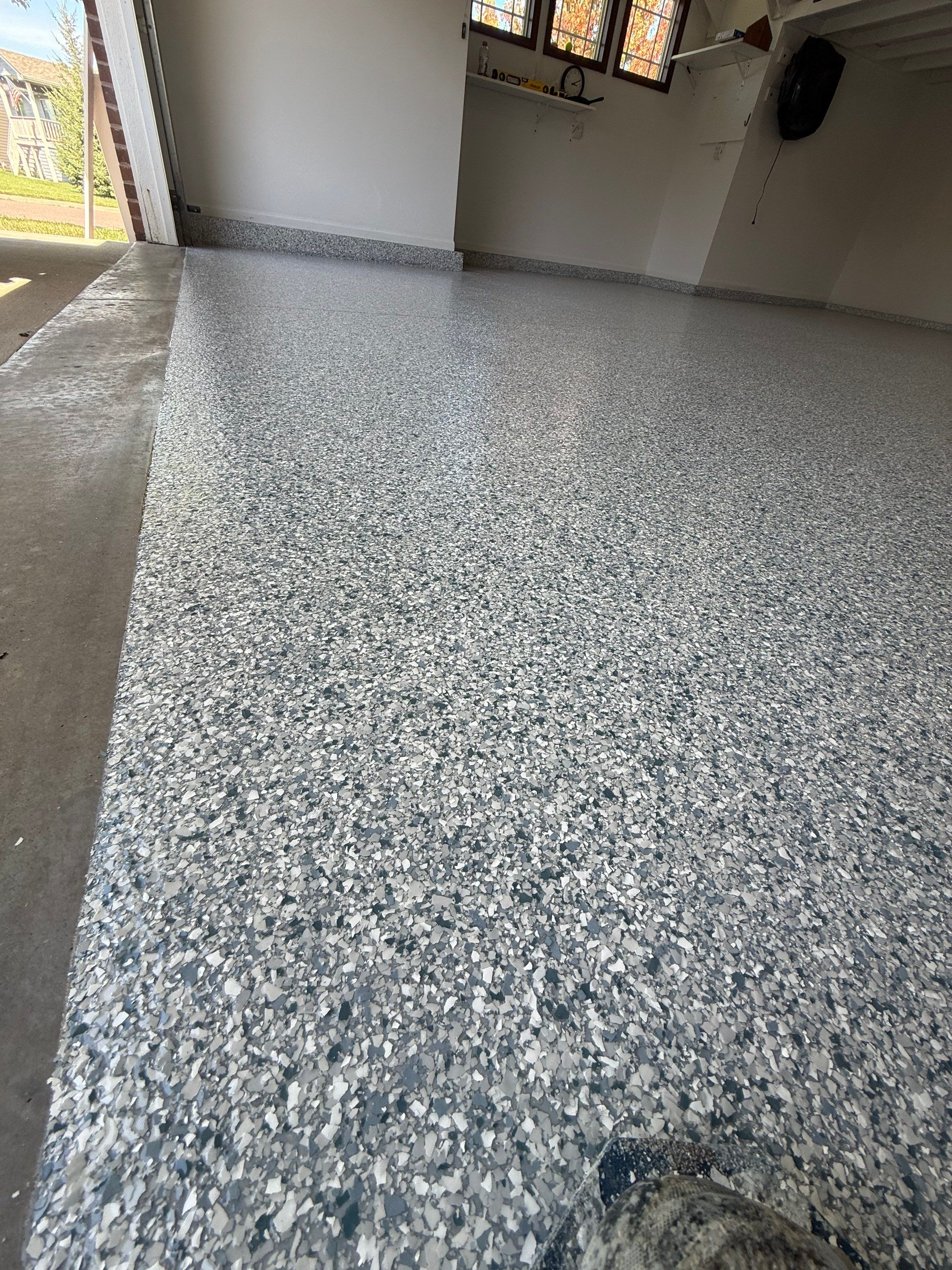Decorative Chip Epoxy Floor Coating Installation in Sioux Falls by Select Painting, Coatings & Garage Cabinets