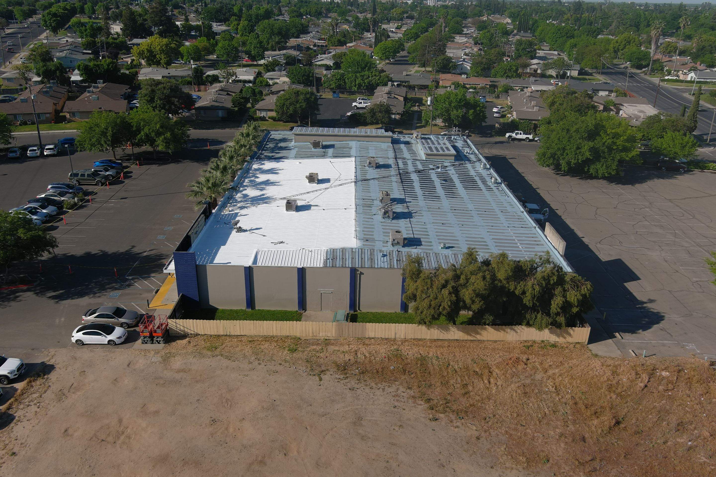 Metal roof restoration on commercial roof using Conklin Benchmark/ PUMA XL acrylic coatings over metal and foam by Straight Edge Roofing Inc