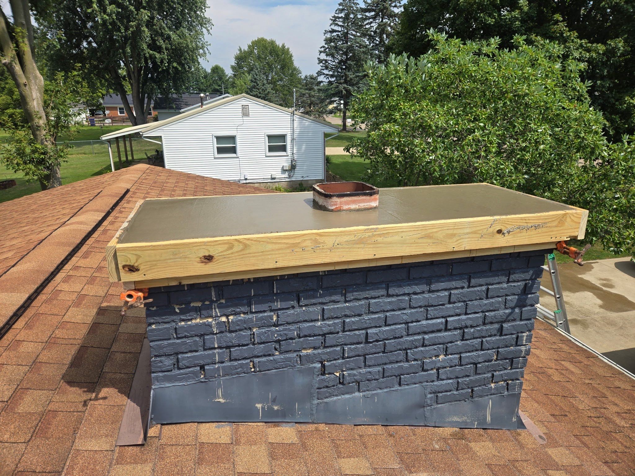 Roof Replacment, Chimney crown  by Know-A-Guy Roofing & Exteriors 