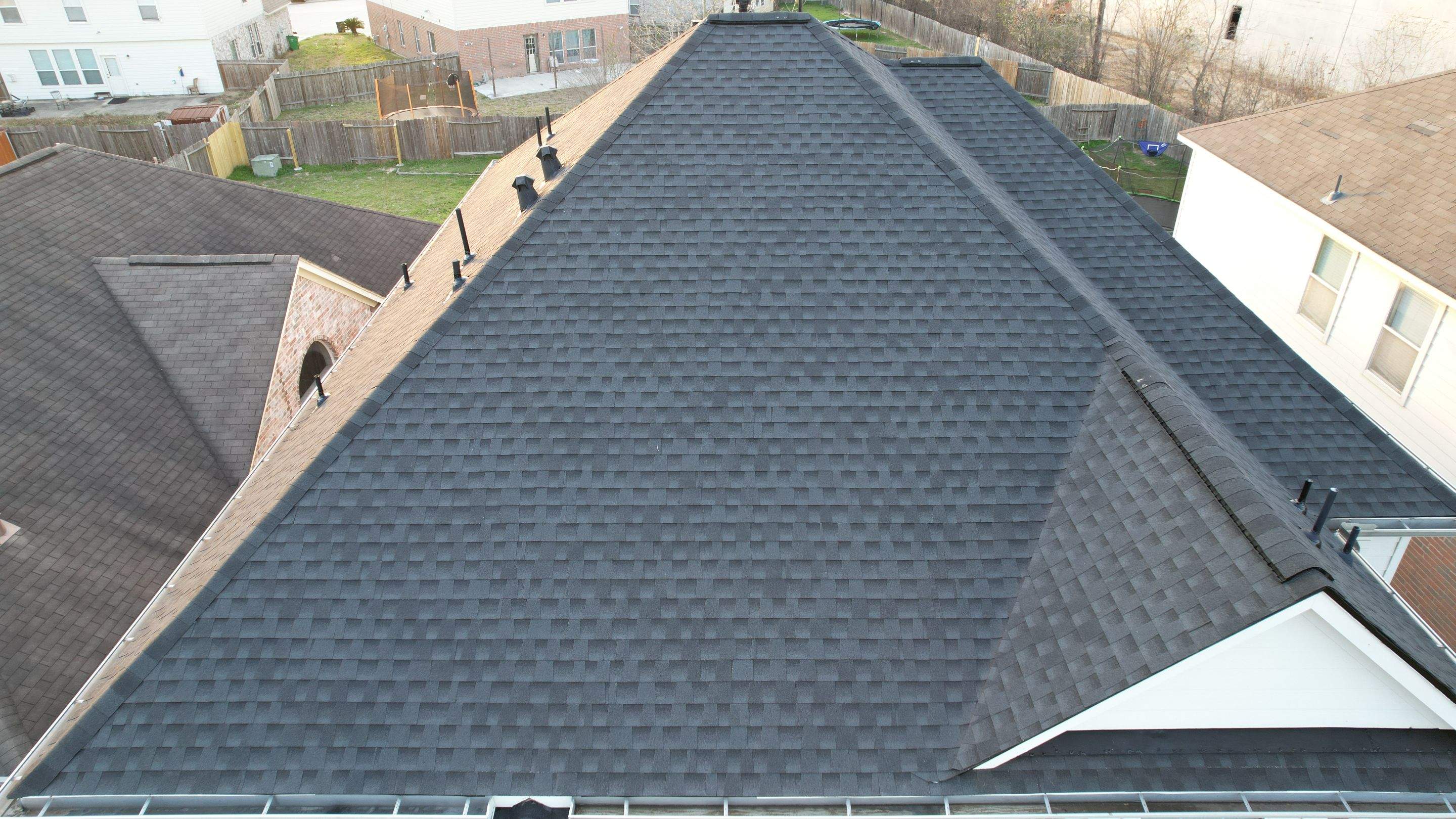 Slate-Gray Roof on Stone-Front Home — Spring, TX by PL Roofing & SB Roofing, LLC.