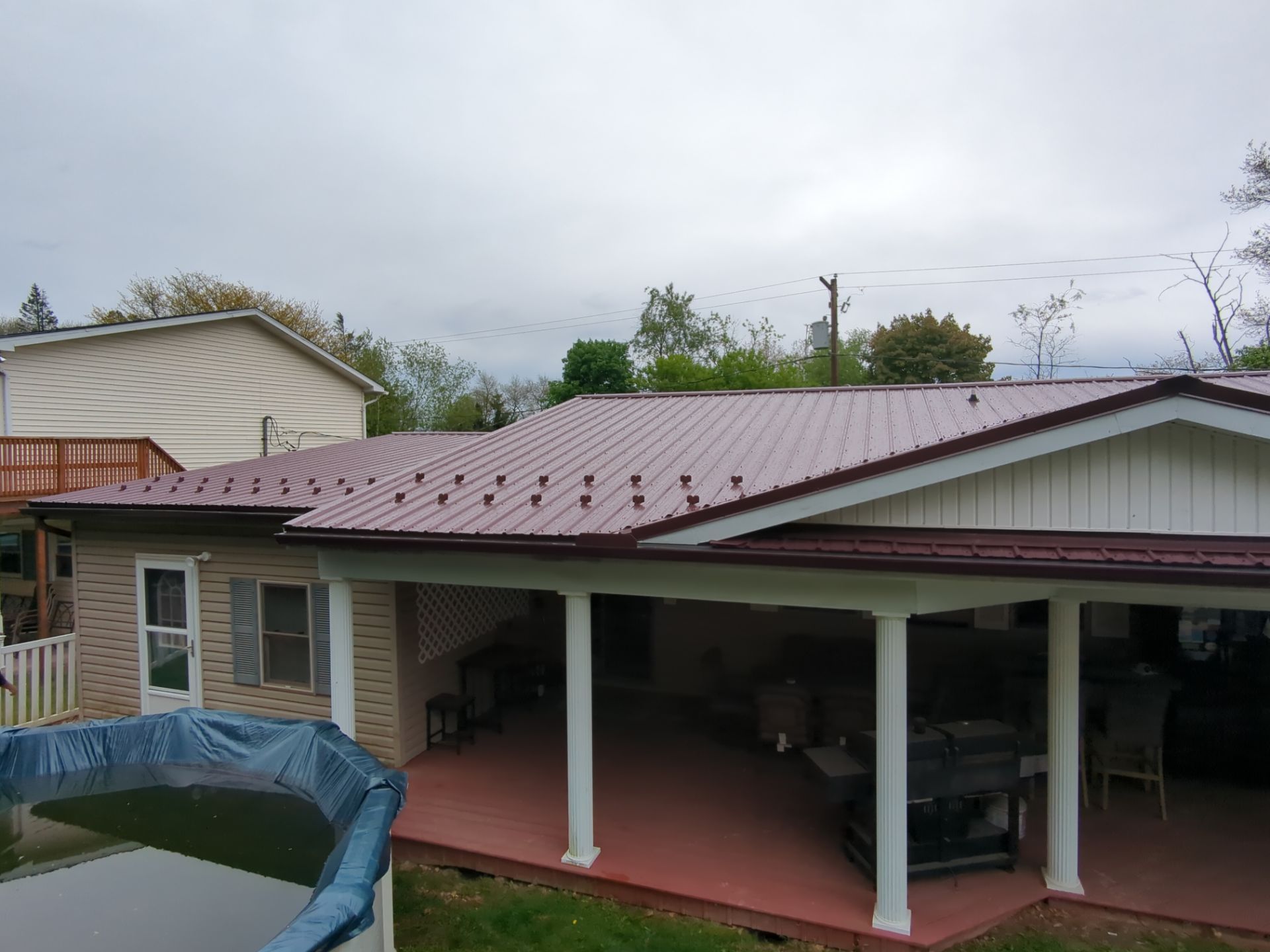 Maroon ABM Metal Roof Replacement and Gutter Installation in Shenandoah by Esh Builders