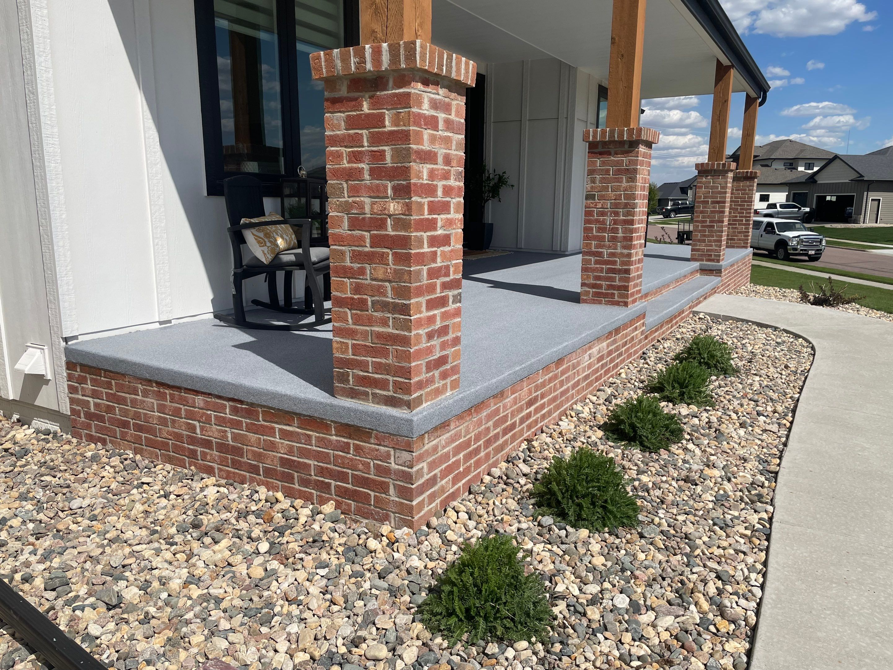 Grey Speckled Concrete Porch Coating for Sioux Falls Home by Select Painting, Coatings & Garage Cabinets