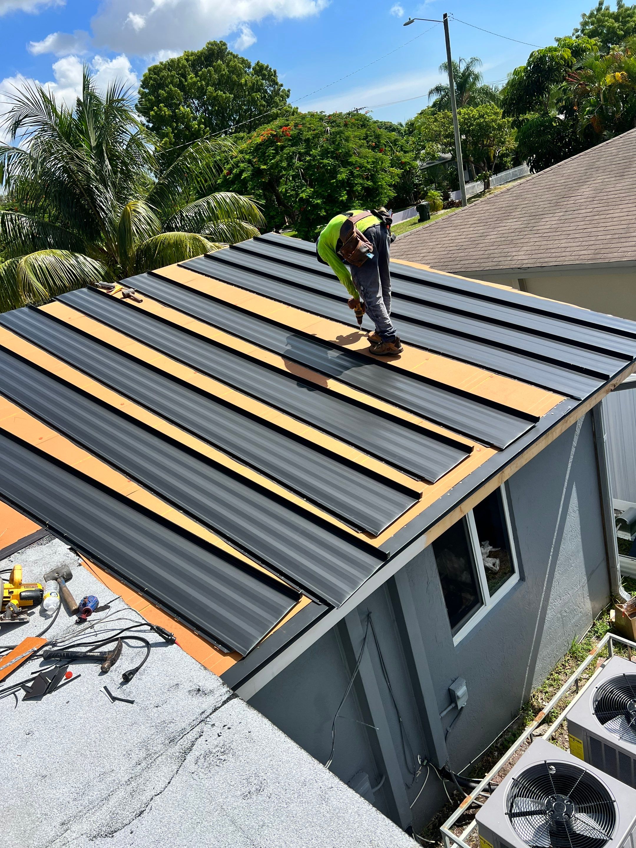 Standing Seam Metal & Flat Re-Roof using 1.5" Nail Strip 24ga Black Matte Kynar Coated Standing Seam Metal Panels by Morton Roofing, Inc.