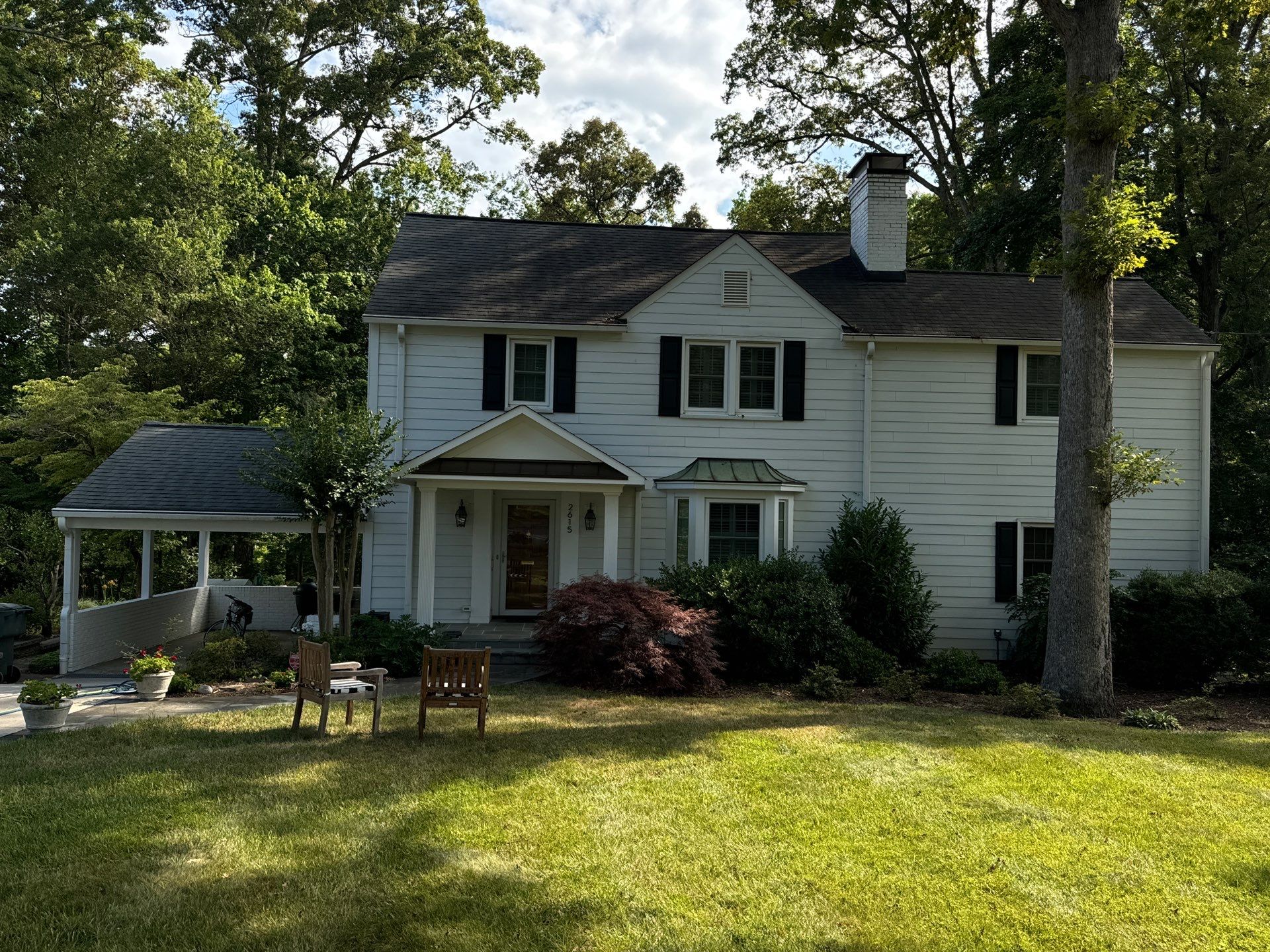 pressure washing company cleaning the house's siding driveway and roof