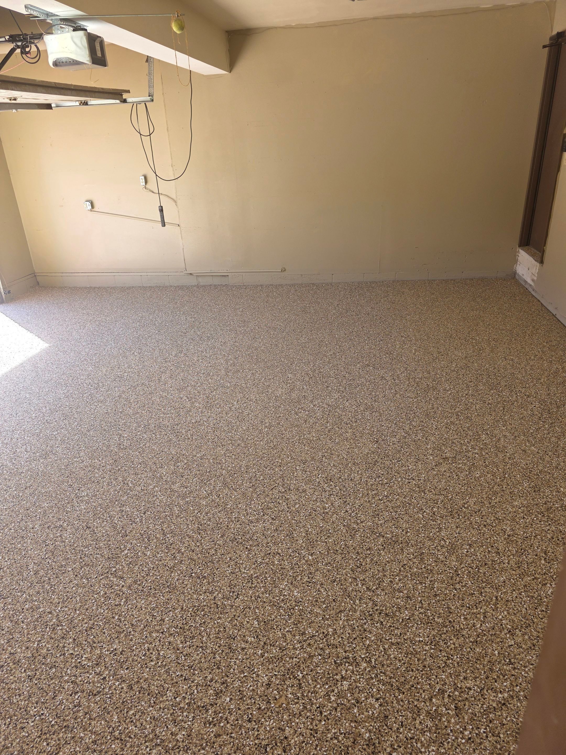 Residential Garage Epoxy Floor Coating Installation in Sioux Falls by Select Painting, Coatings & Garage Cabinets