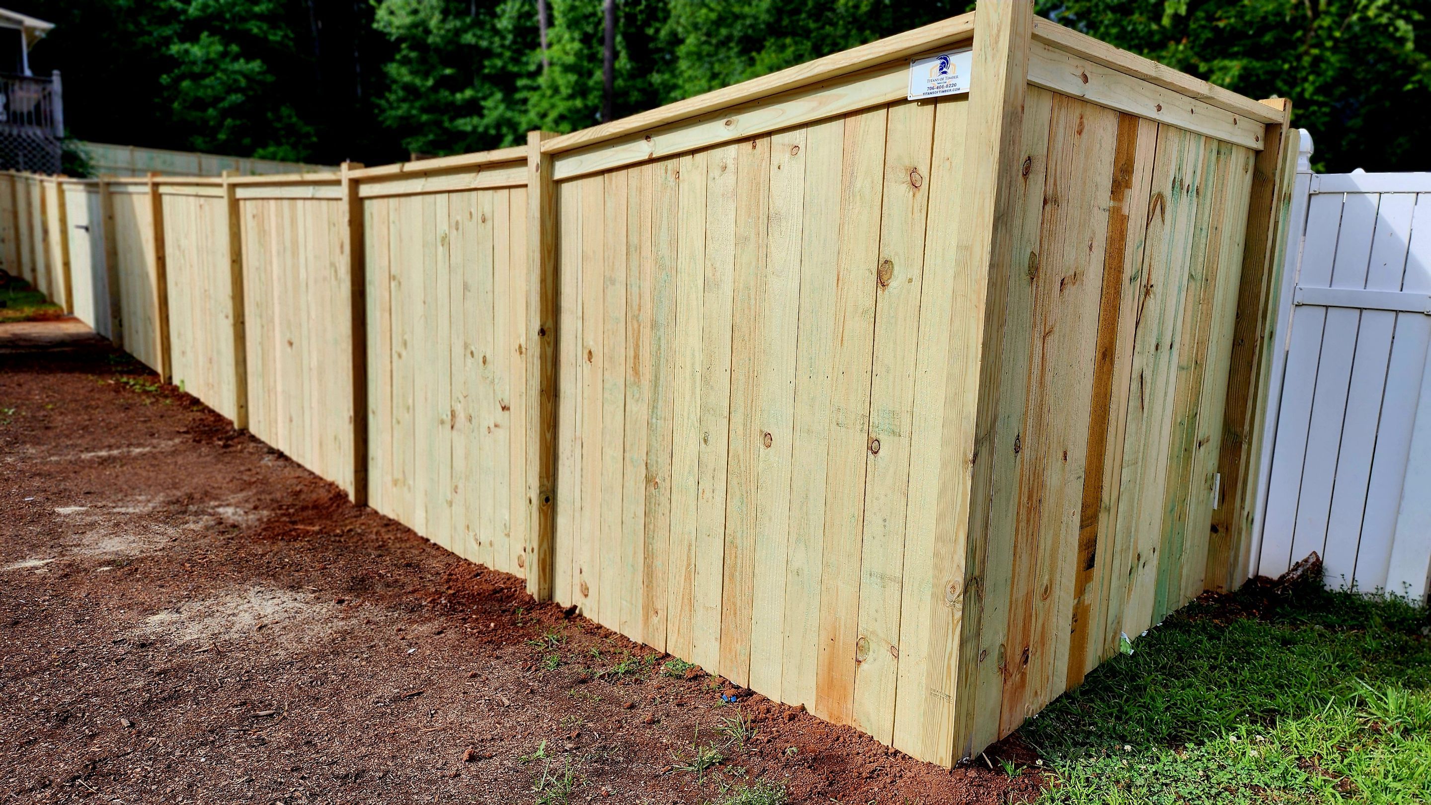 Fence Installation of Capped Wood Privacy Fence by Titans of Timber Fence & Stain