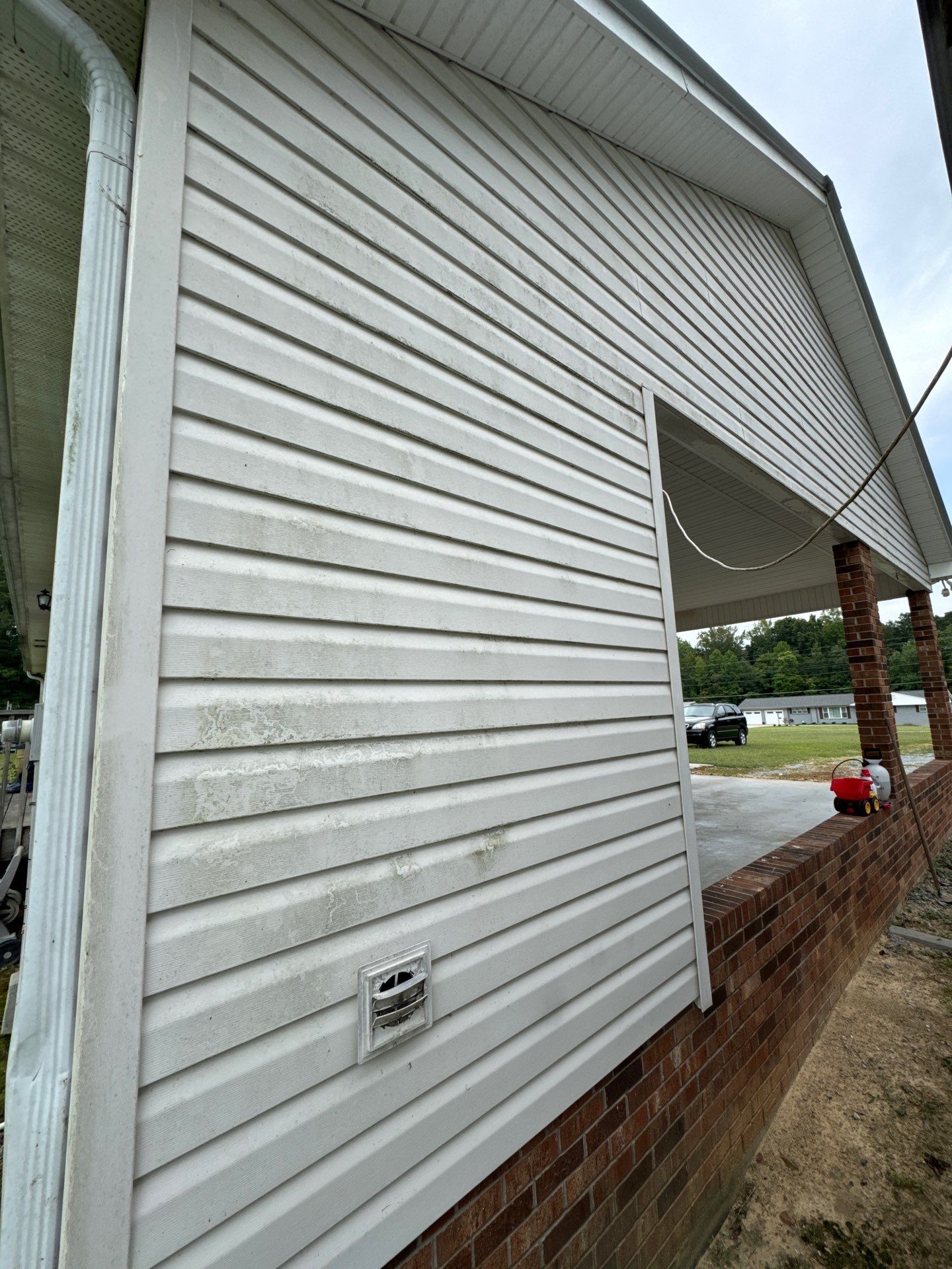 the service shown is cleaning the house siding to remove dirt and mold for a refreshed appearance and maintenance