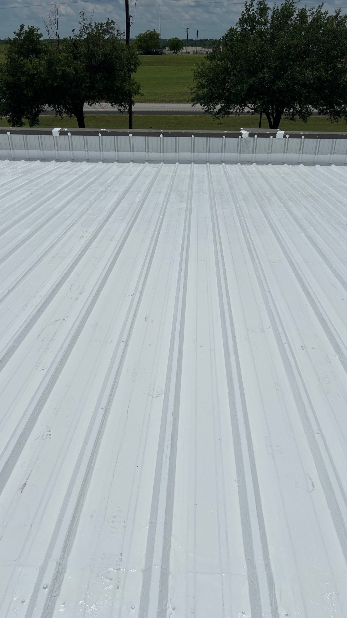 Commercial Roofing Installation using TRP #924 Eterna-Sil Premium Silicone Roof Coating by Harvey Roofing & Construction