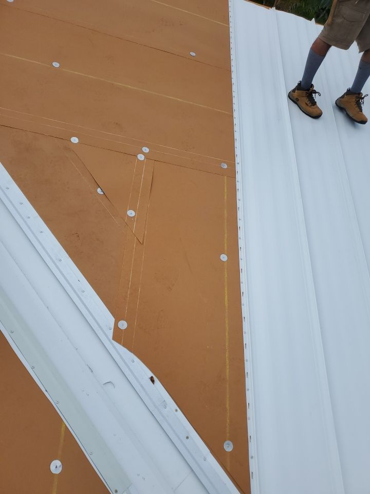 Residential Roofing Installation using 1.5" Nail Strip 24ga Solar White Kynar Coated Standing Seam Metal Panels by Morton Roofing, Inc.