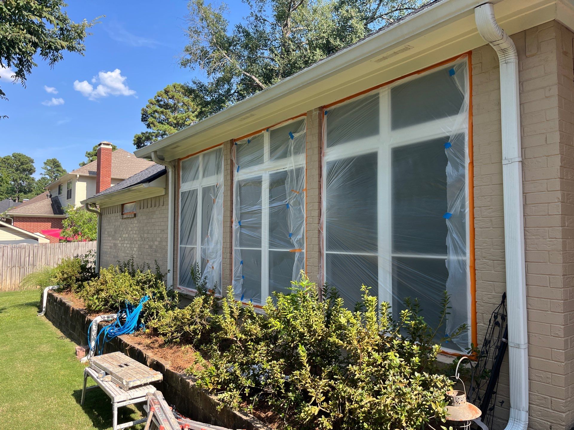 Exterior Painting in Tyler, TX | Brick House with White & Blue Finish by Quality Coats Painting