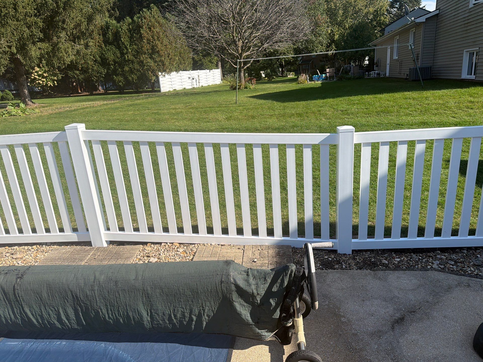 White Vinyl Picket Pool Fence Installation in Waterloo, Iowa by Perfect Picket Fence and Stain