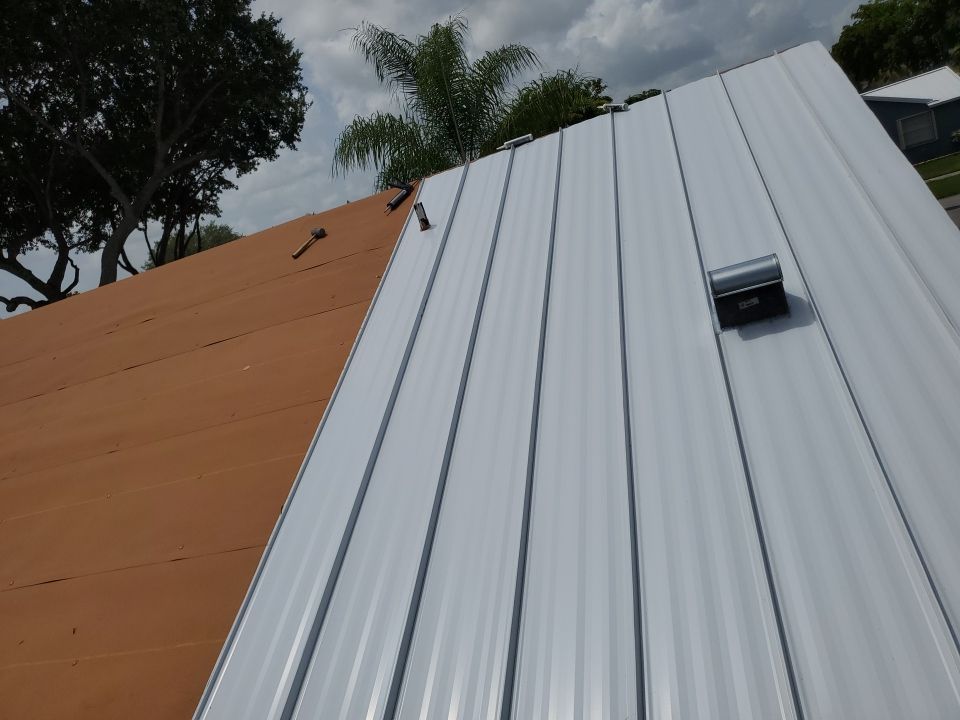 Residential Roofing Installation using 1.5" Nail Strip 24ga Solar White Kynar Coated Standing Seam Metal Panels by Morton Roofing, Inc.